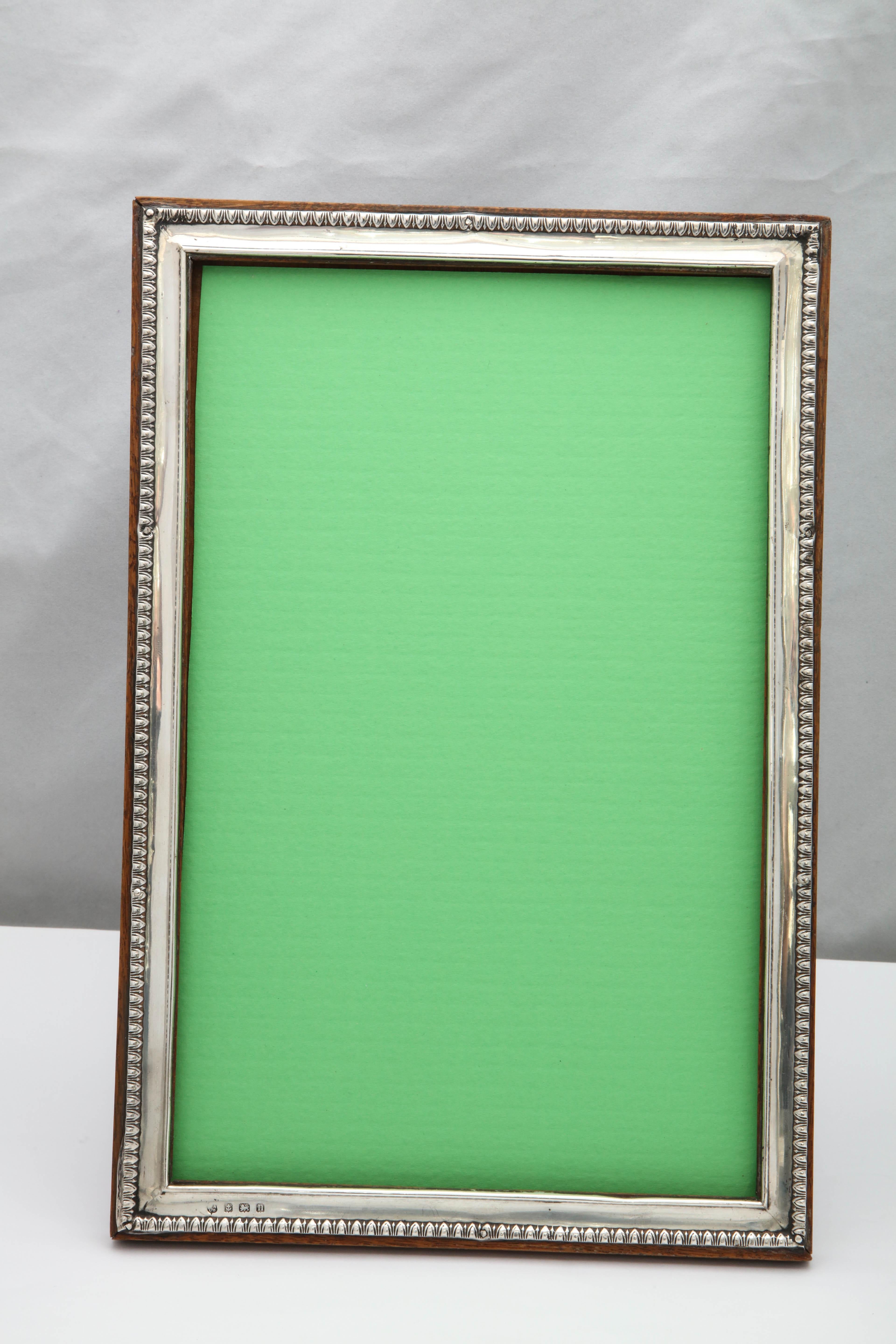 Rare, large, Edwardian, sterling silver picture frame, Birmingham, England, 1912, W. Neale and Sons, Ltd. - makers. Will stand both horizontally and vertically. Egg and dart border. Measures: Stands 12 1/4 inches high x 8 1/4 inches wide (when