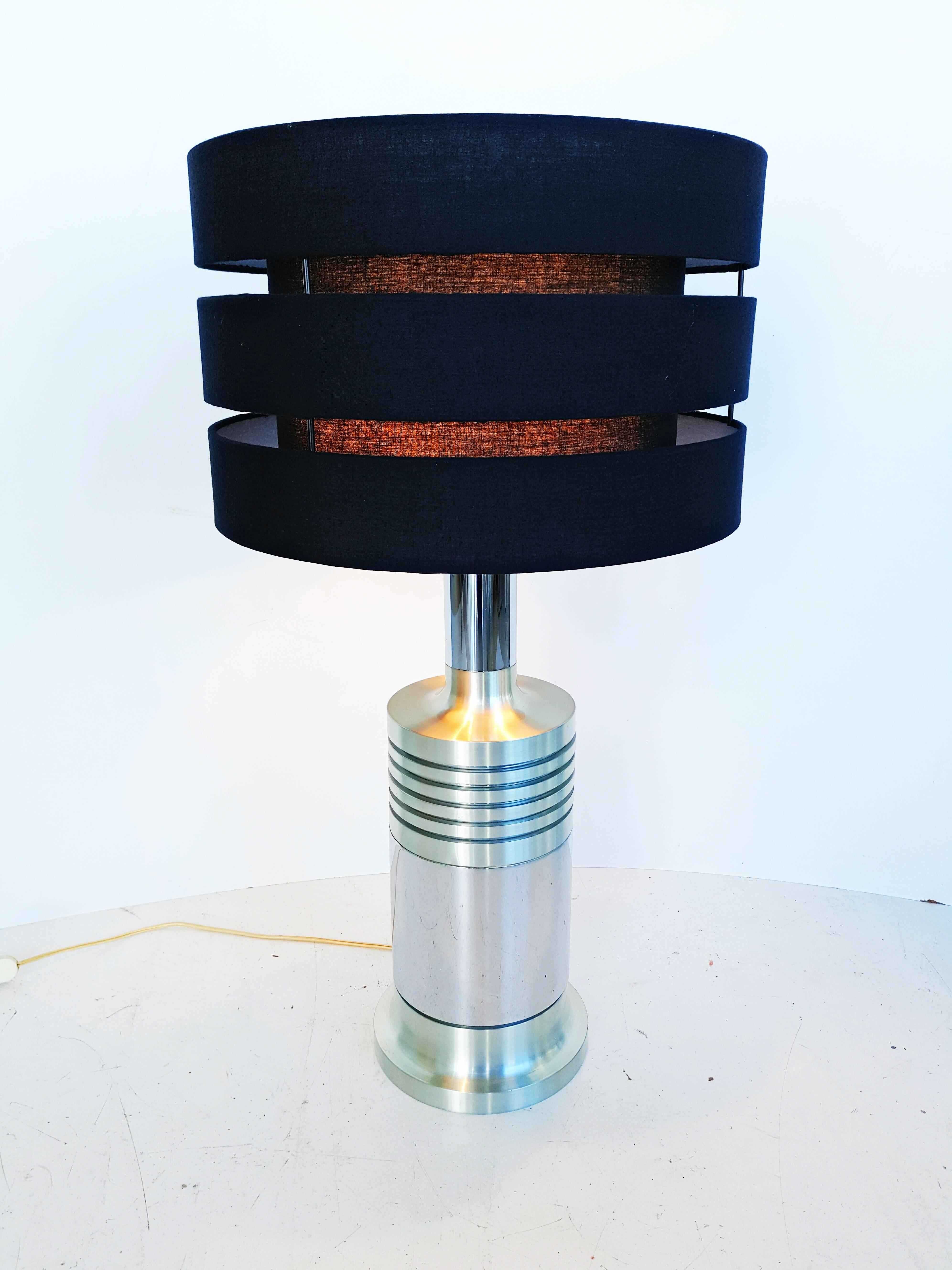 Beautiful and rare large French table lamp manufactured in 1970s. In brush aluminum and chrome with its triple black lampshade. In perfect vintage condition.