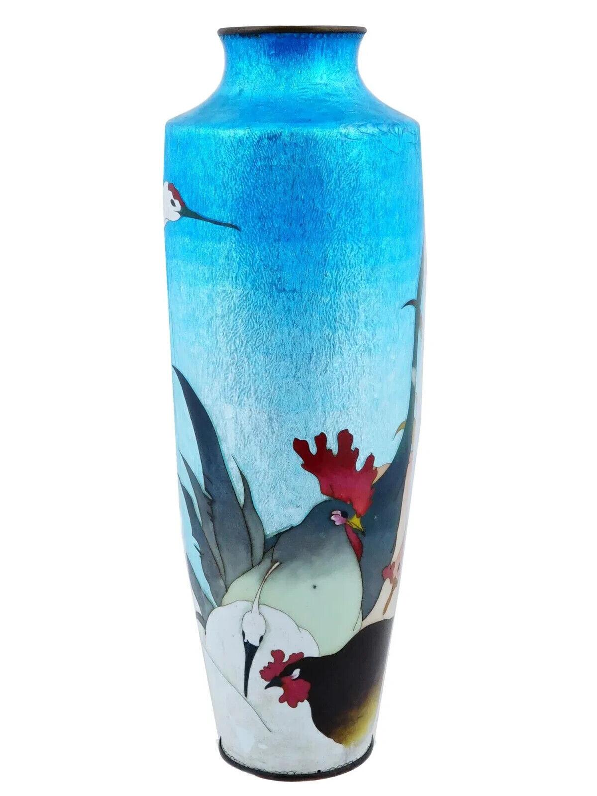 A rare large Japanese Ginbari enamel over copper vase. The urn shaped vase is enameled with a polychrome design representing cranes, hens, roosters and other birds made in the Ginbari Cloisonne technique. Ginbari is a Japanese cloisonne technique