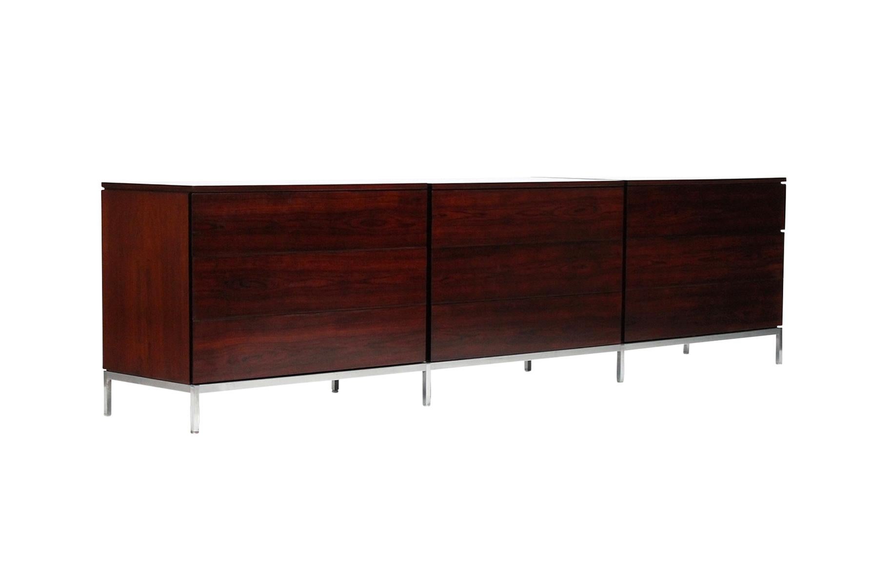 Long rare dresser in rosewood designed by Florence Knoll for Knoll International. Each section with three drawers, all drawers with original dividers, on long chromed steel base. One section with the original Knoll paper label to the underside.
  