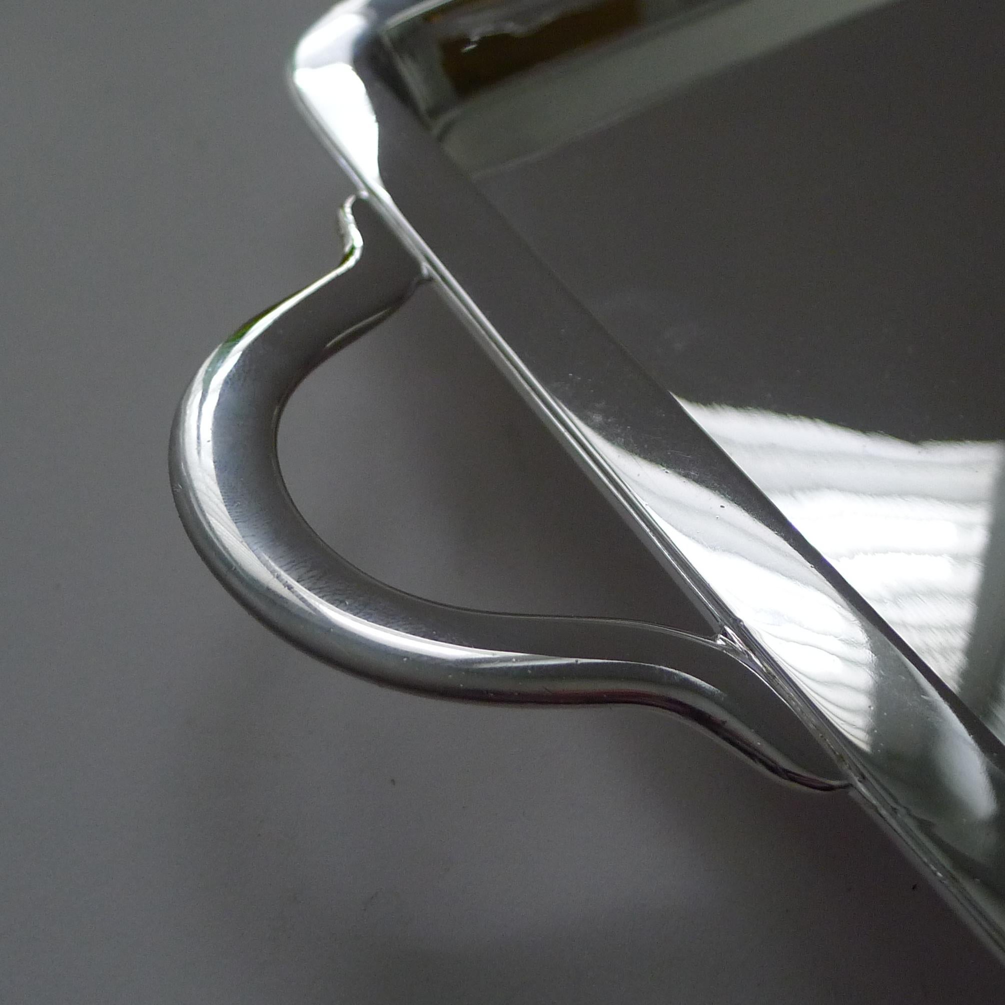 A most unusually shaped tray, very long and slim, a truly elegant example.  The silver plated tray is made by the top notch and highly collectable silversmith, Hukin & Heath, fully marked on the underside.

The tray retains a highly decorative