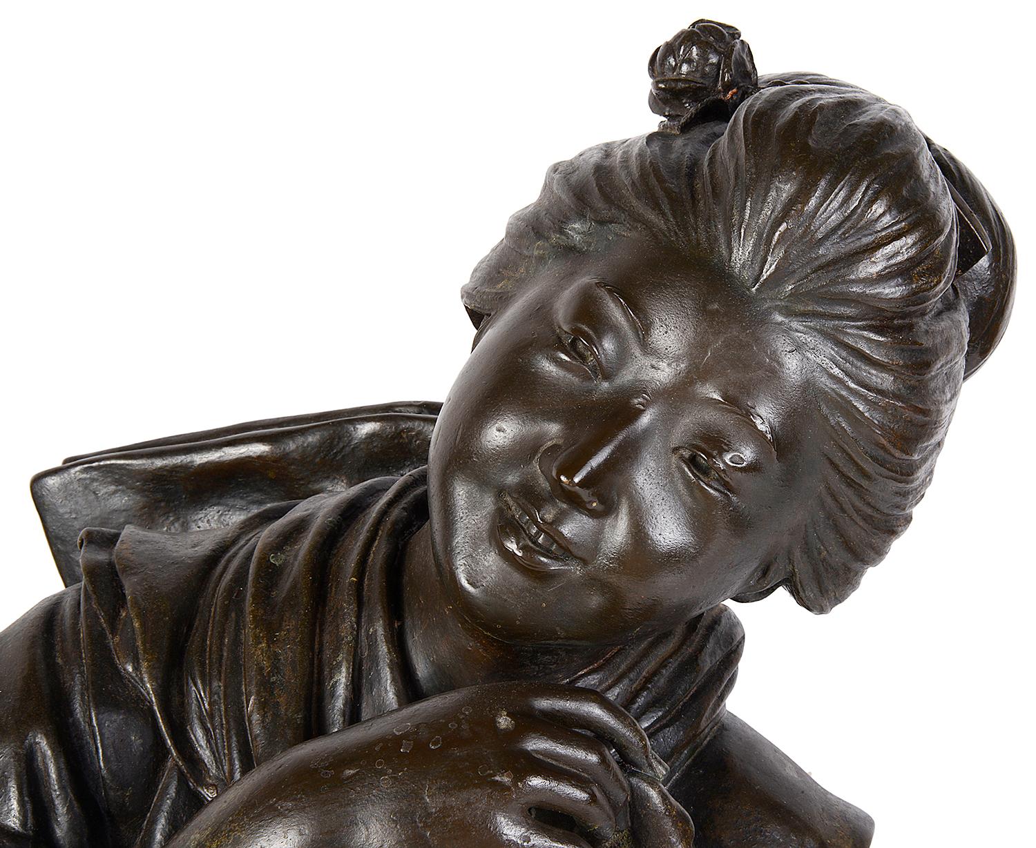 An very impressive large Japanese Meiji period (1868-1912) bronze statue of a reclining female.