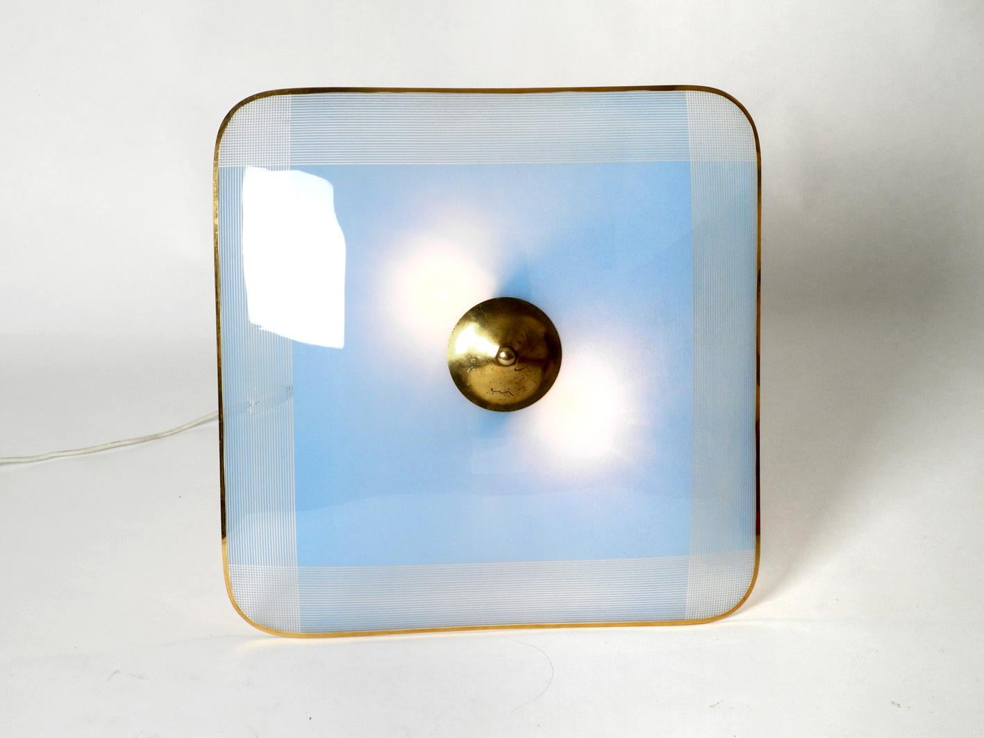 Very high quality rare Mid-Century Modern square ceiling pendant ceiling lamp by Doria. The original label unfortunately fell off during cleaning. Large slightly arched square glass shade. Inside elaborately blue coated and at the edge in brass