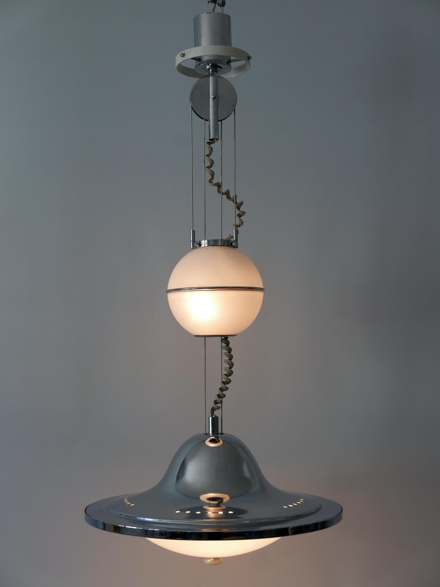 Gorgeous, extremely rare and highly decorative Mid-Century Modern counterweight pendant lamp or hanging light 'UFO'. Designed & manufactured in Italy, 1960s.

Executed in chrome-plated metal and white lucite, the pendant lamp needs 3 x E27 / E26