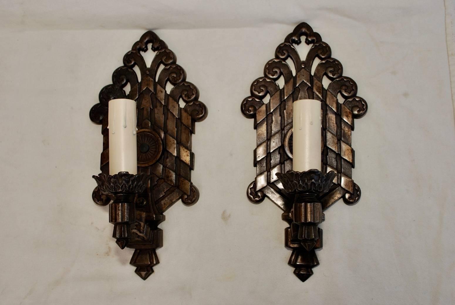 A rare pair of large 1920s cast iron sconces, they have been restored, they are quite heavy.

 