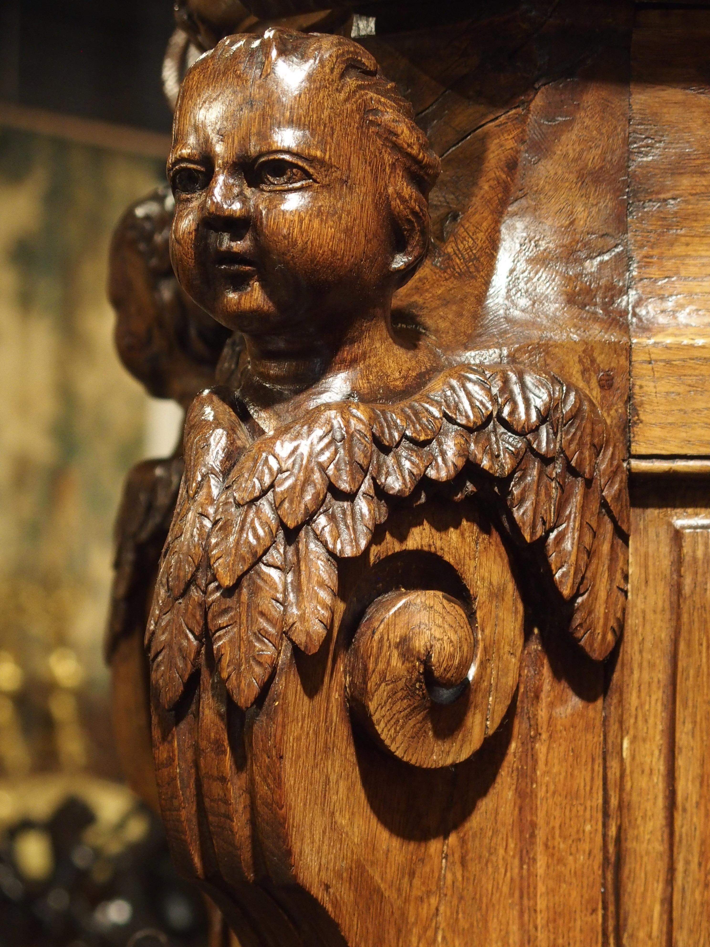 From the 1600s, this rare, large scale, light oak, hand-carved sacristy cabinet once held sacred objects of a catholic church in France. The Parisian family who owned it most recently, have supplied black and white photos showing the piece in a