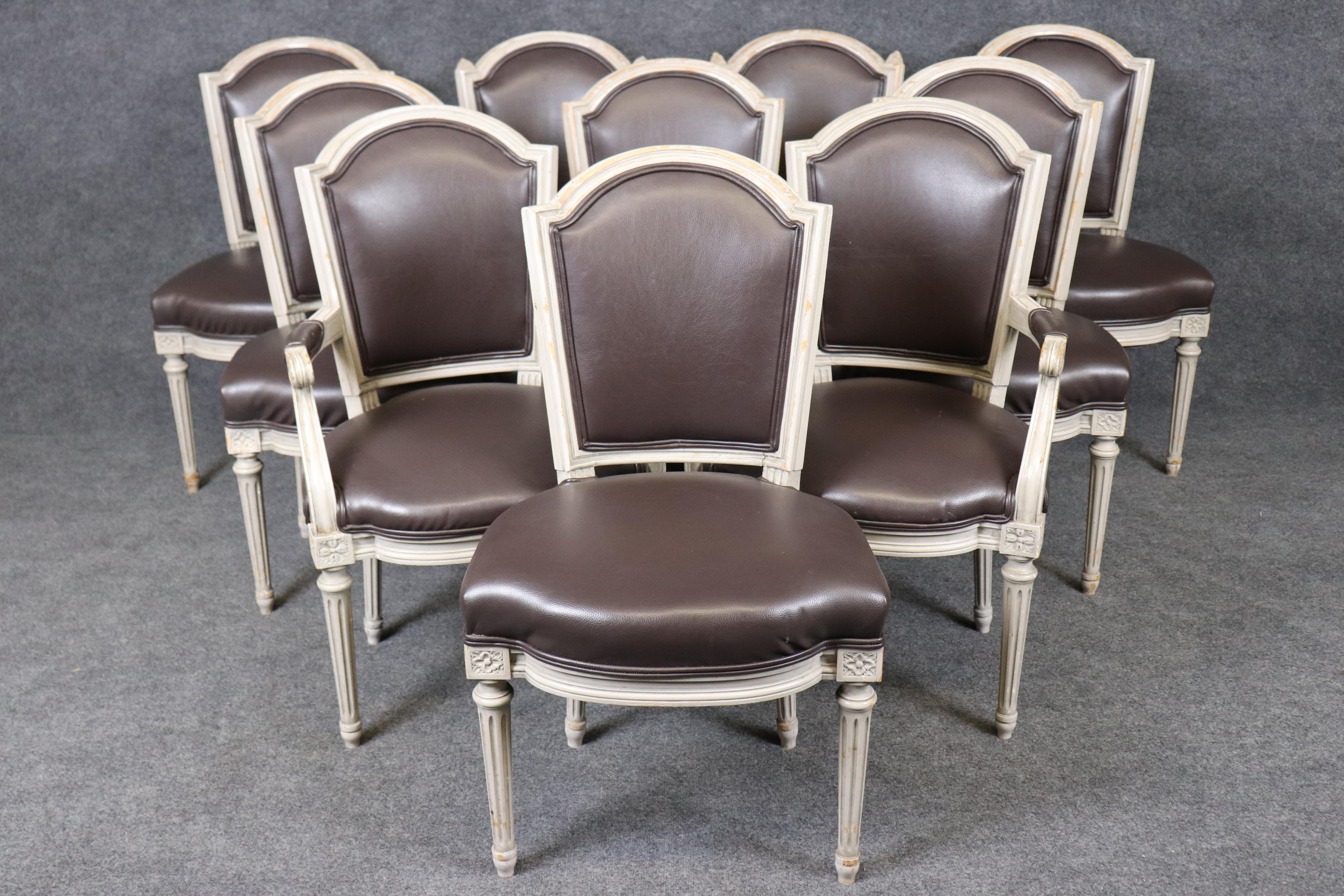 Bring timeless French elegance into your home with this exceptional set of Louis XVI style distressed painted dining chairs, crafted in the refined Maison Jansen manner. Featuring hand-carved frames with distressed cream paint finish, these chairs