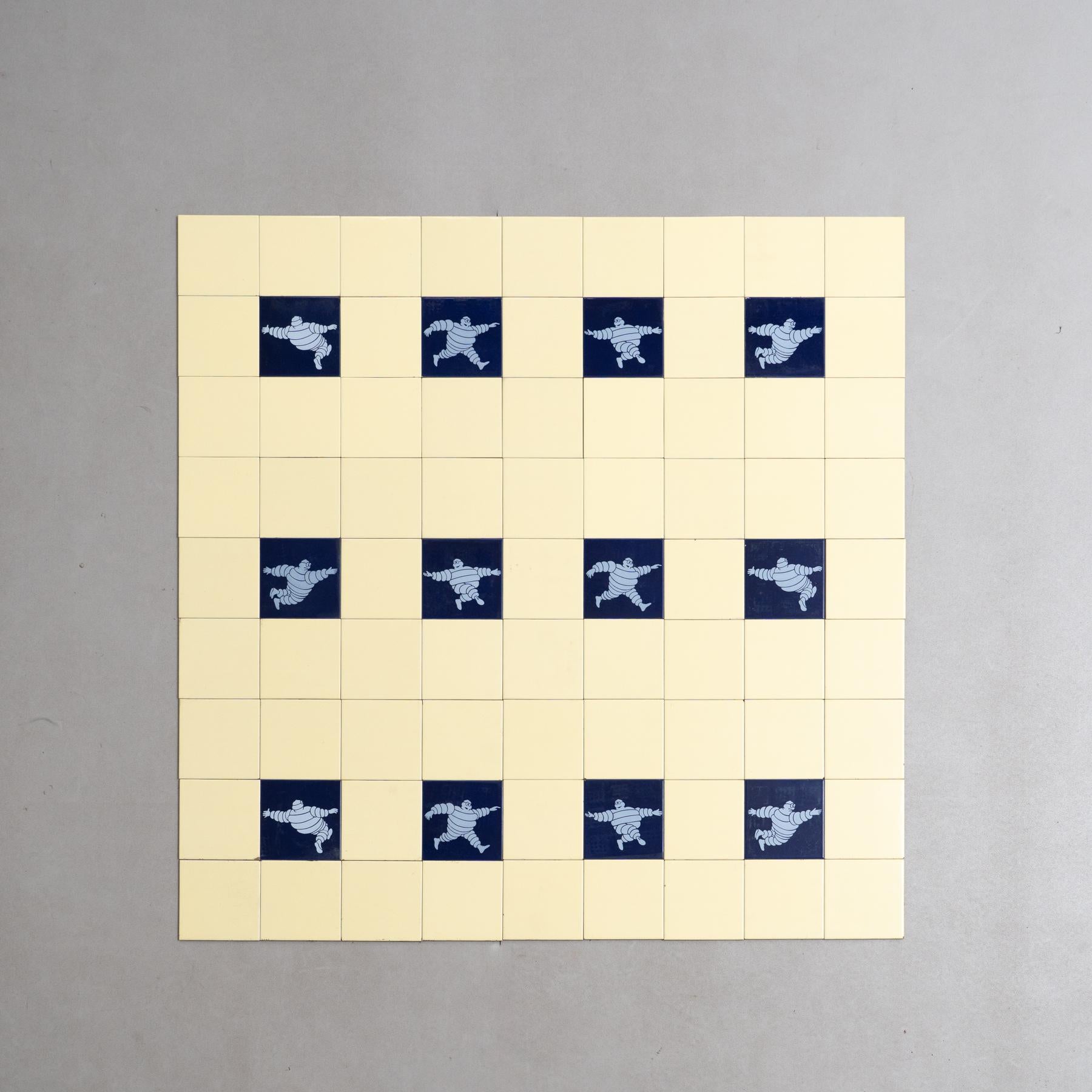 Dive into a nostalgic journey with this rare and unique large set of Michelin Man tiles, crafted by an unknown manufacturer in Spain circa 1960. The set comprises the iconic Michelin Blue Tiles, surrounded by original yellow tiles, creating a