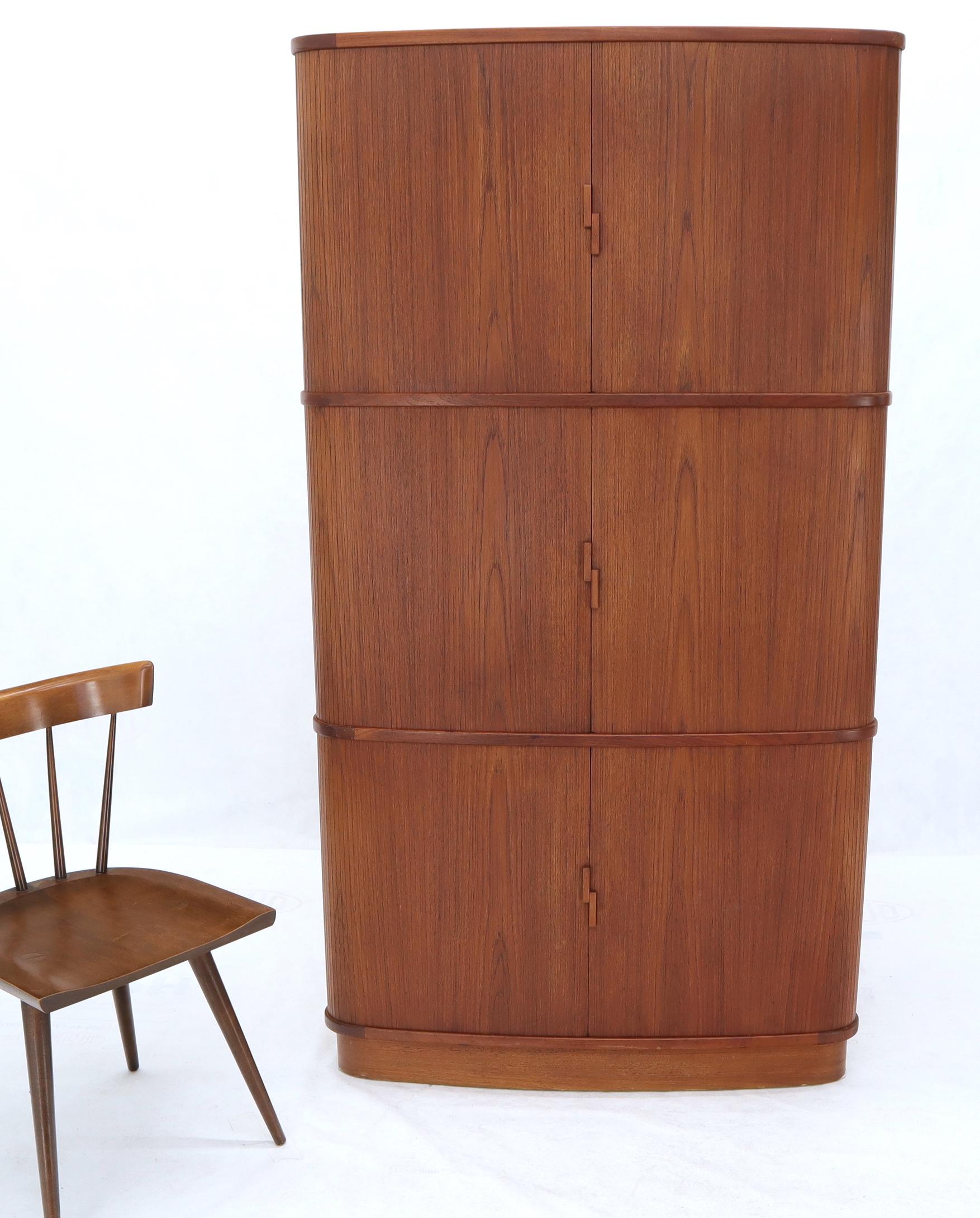 Very fine quality Danish Mid-Century Modern corner cabinet. Featuring famous Danish tambour door credenza style design very unusual a corner cabinet.