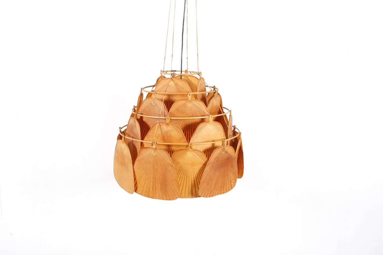 Largest version of the Uchiwa fan chandelier in very good original condition.

Designed by Ingo Maurer for M design, Germany.

This lamp is handmade from bamboo and Japanese rice paper. 

The lamp consists of 30 fans hanging from a four-tier