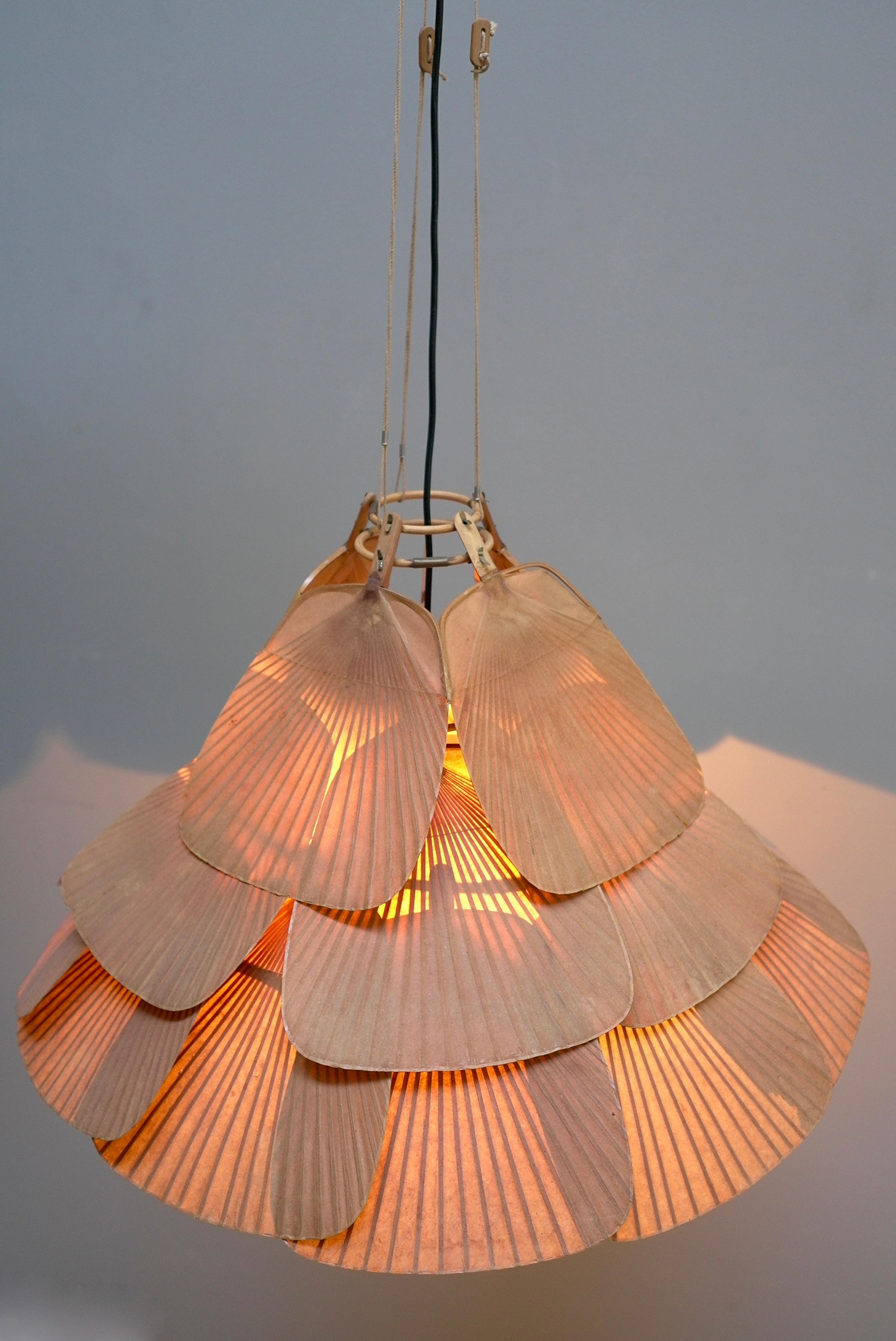 Rare large Uchiwa Fan chandelier by Ingo Maurer for M Design 1975

This lamp is handmade from bamboo and Japanese rice paper.

With cord the lamp is 120cm in height (and adjustable) the width is 70cm. Without cord it is 45 cm in height.