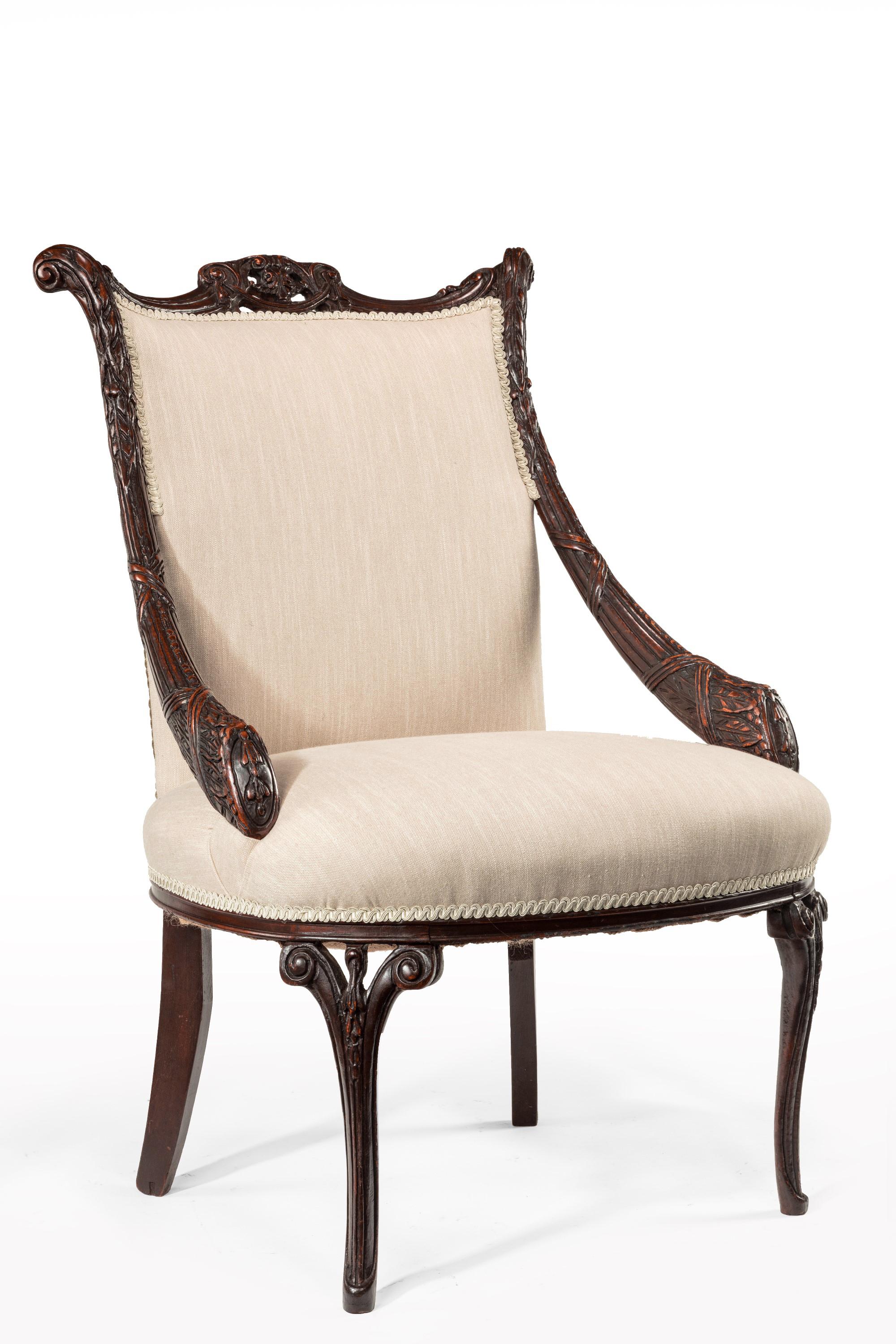 A rare and very unusual late 18th century European mahogany open armchair upholstered in linen possibly from Berlin.

European, circa 1790-1800.


The festooned and pierced double scrolled top rail above a curved padded linen upholstered back