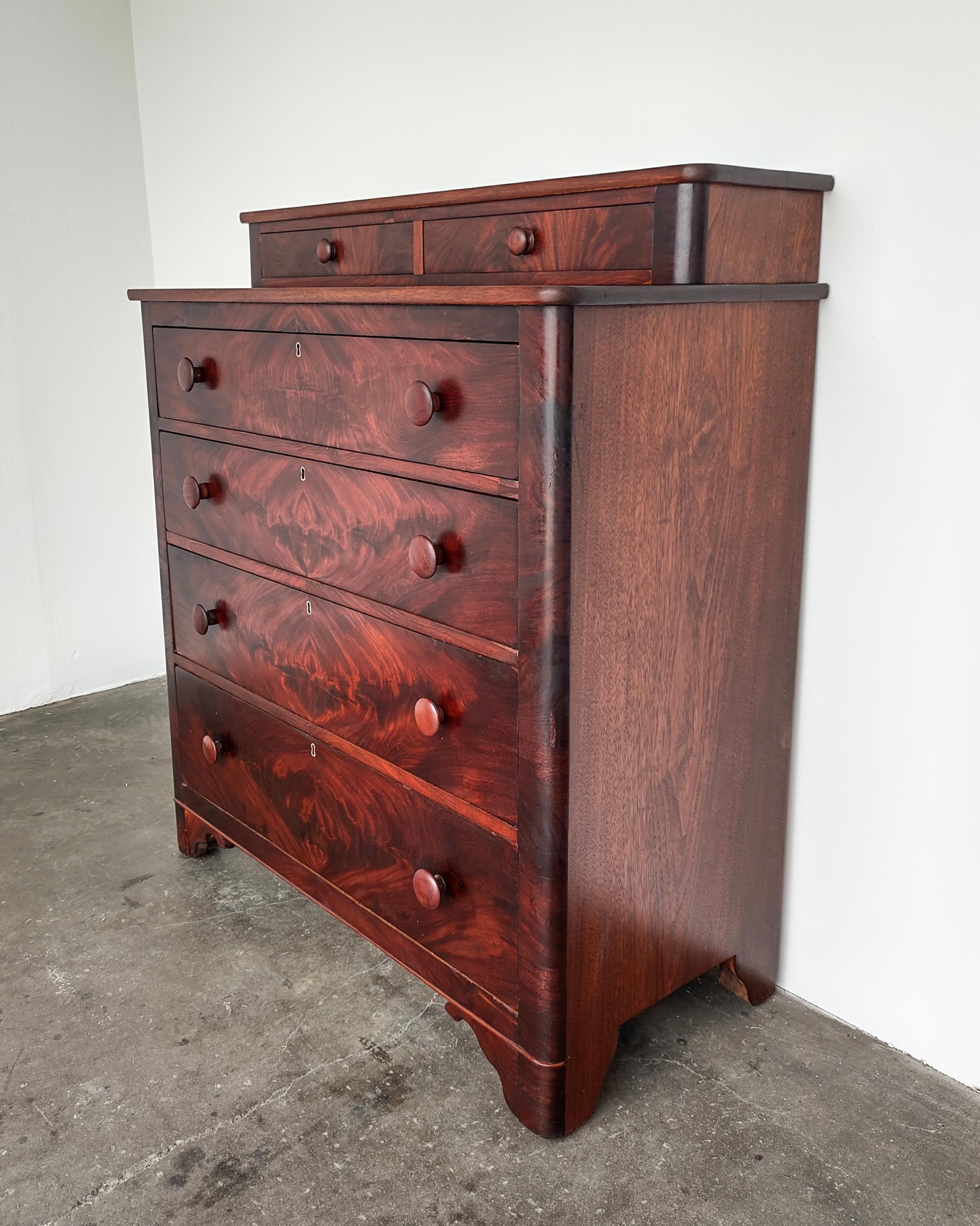 Rare book-matched black walnut highboy dresser circa 1890s. Professionally refinished with 100% natural non-toxic matte/satin oil finish. Four large drawers with an additional two small on top. Solid wood construction with gorgeous deep walnut wood