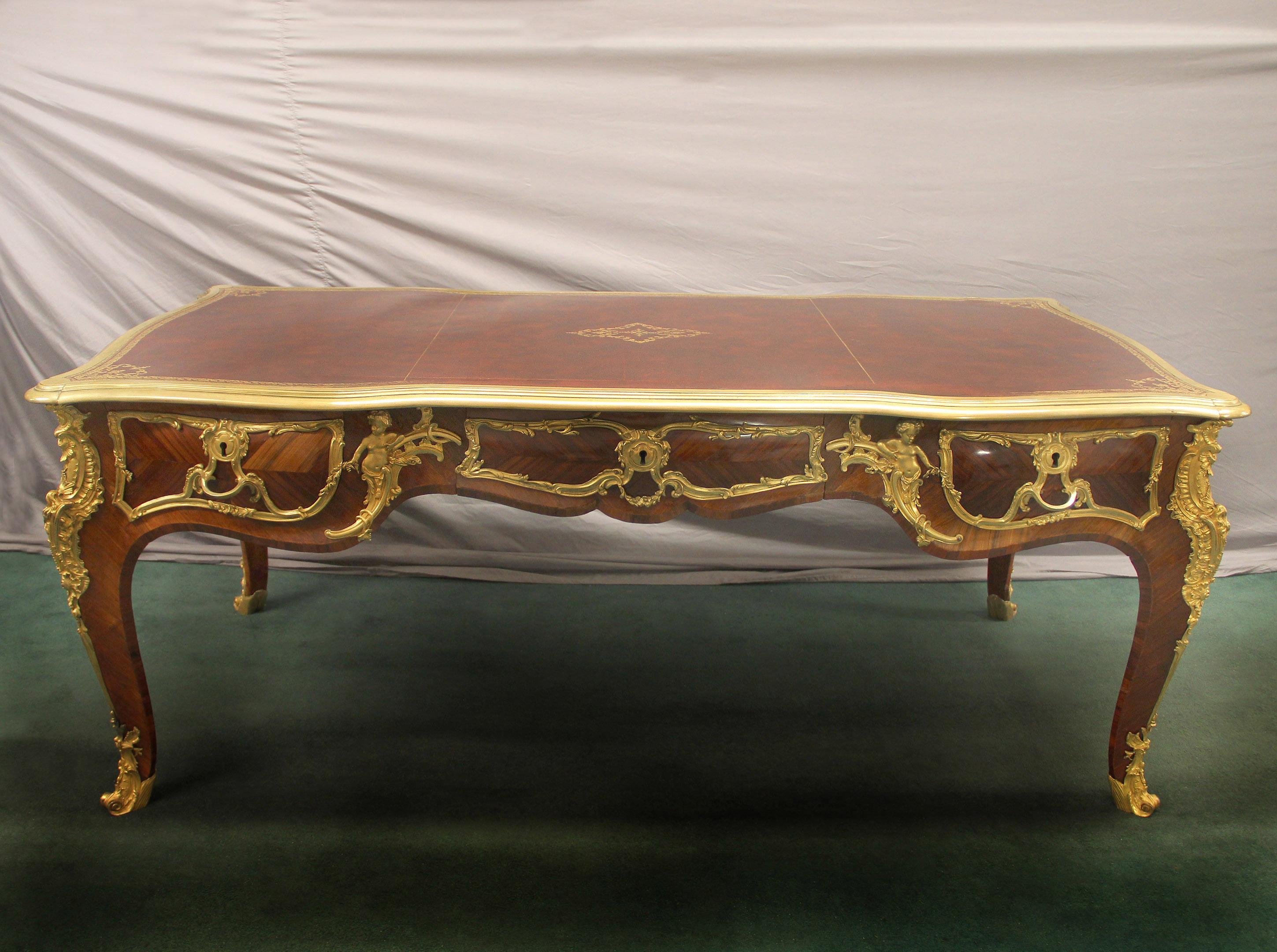 An exceptional and rare late 19th century gilt bronze mounted Louis XV Style Bureau Plat Attributed to Zwiener

Attributed to Joseph Zwiener

The serpentine case with a rectangular top with gilt-tooled leather writing-surface within a molded