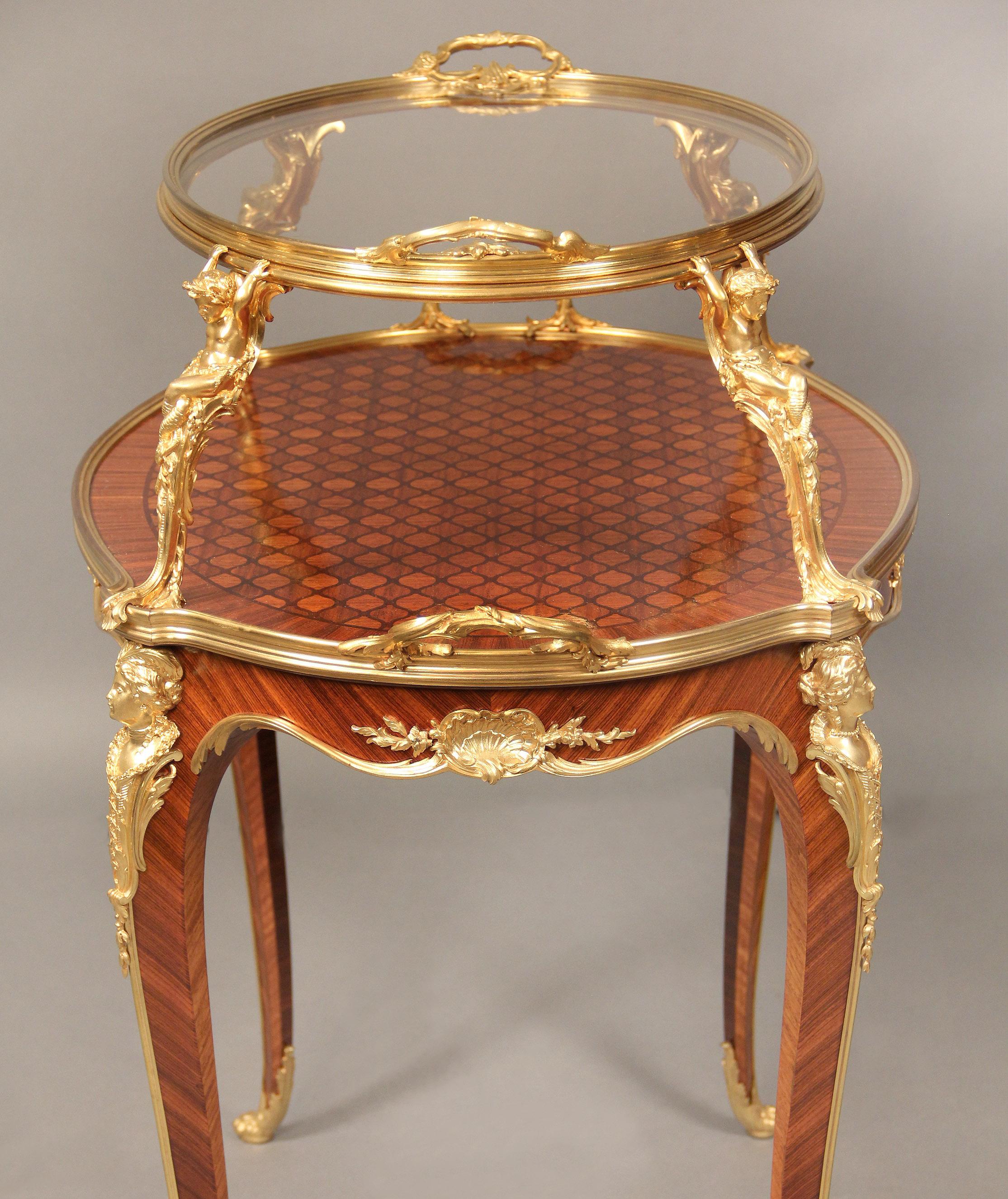 A fantastic quality and very rare late 19th century gilt bronze mounted inlaid parquetry tea table by François Linke

François Linke – The Mounts by Léon Messagé – Varient of Index Number 610

The oval dual-handled upper tier with removable