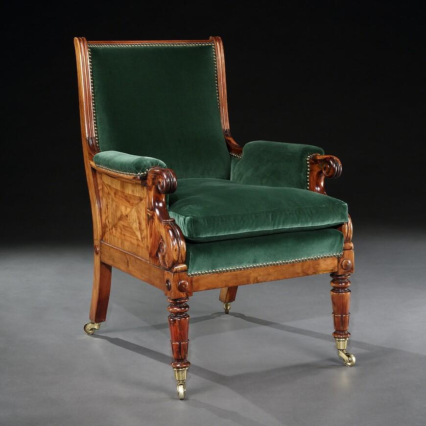 A rather splendid late Regency Yew wood library bergère armchair in a festive bottle green velvet.

English, circa 1825

The padded oblong back above a cushioned seat within padded double scroll-ended arms, the solid sides most unusually banded
