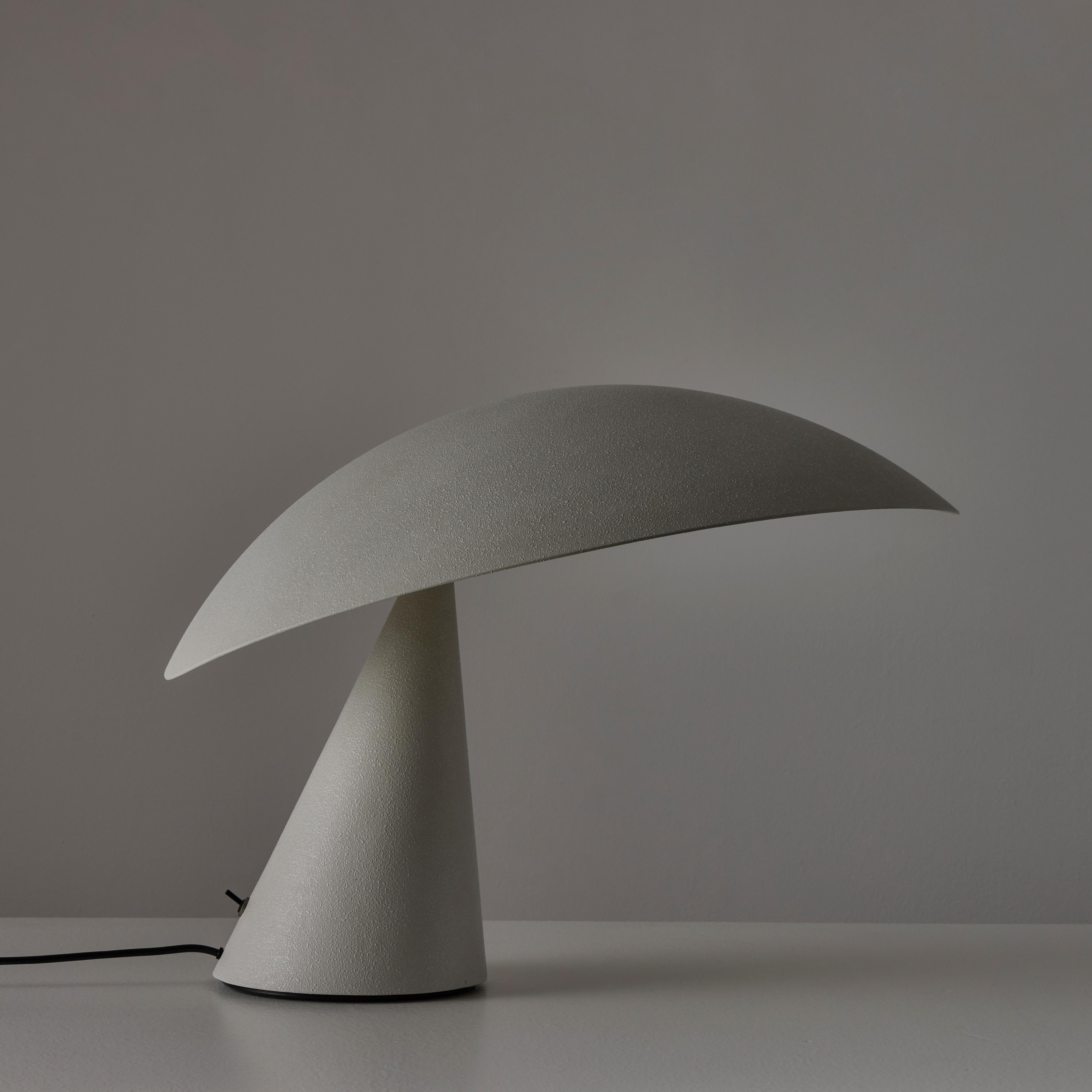 ‘Lavinia’ Table Lamp by Masayuki Kurokawa for Artemide (IT, 1988)

Casted aluminum curved construction, with a grainy textured surface finish. The upper shade can be tilted slightly for some light manipulation. The lamp holds a bi pin g6.35 - g8