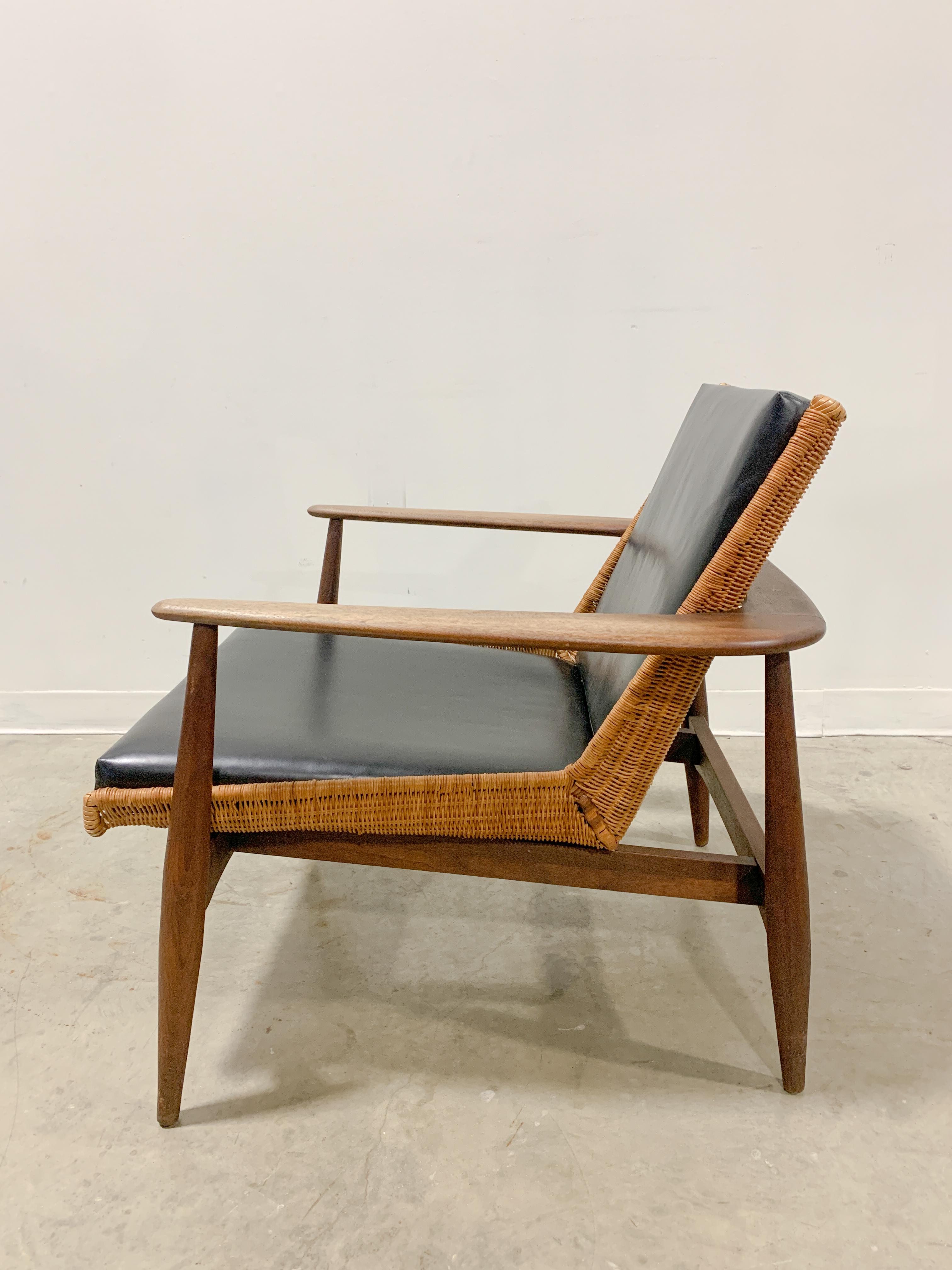 Rare solid walnut version of Lawrence Peabody's stunning model 1806 / 917 chair design made by Richardson Nemschoff in the early 1960s. Unique wraparound arm design cradles a woven basket shell seat that was sourced directly from weavers in Hong