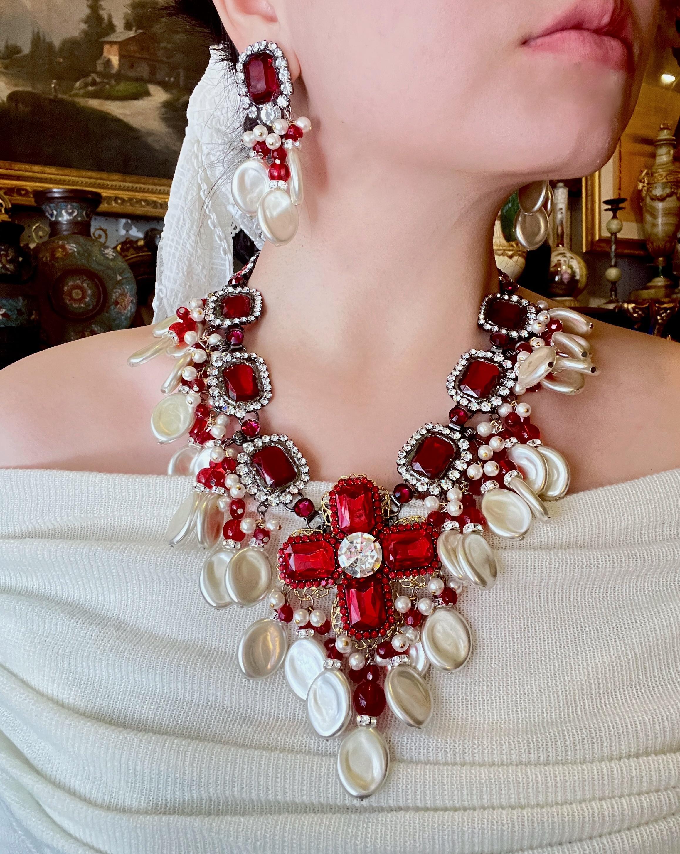 Rare Lawrence Vrba Red Rhinestone Faux Baroque Pearl Necklace & Earrings Parure

Marked:
Lawrence VRBA

Approximate Dimensions: 

Necklace:
51 cm (Unclasped Length) 
11.7 cm -1.3 cm (Width) 
224.9 grams in weight.

Earrings:
8 cm (Length) 
5 cm