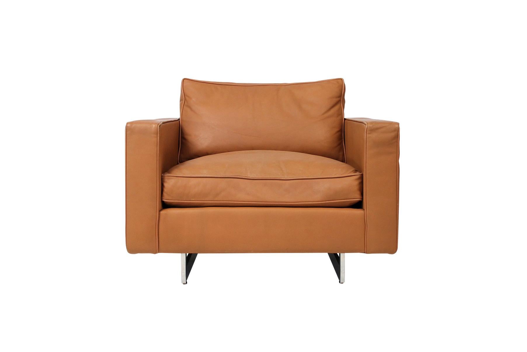 Rare large scale and comfortable lounge chair by noted American designer Jens Risom. In original brown leather with down cushions and chrome sled bases.
