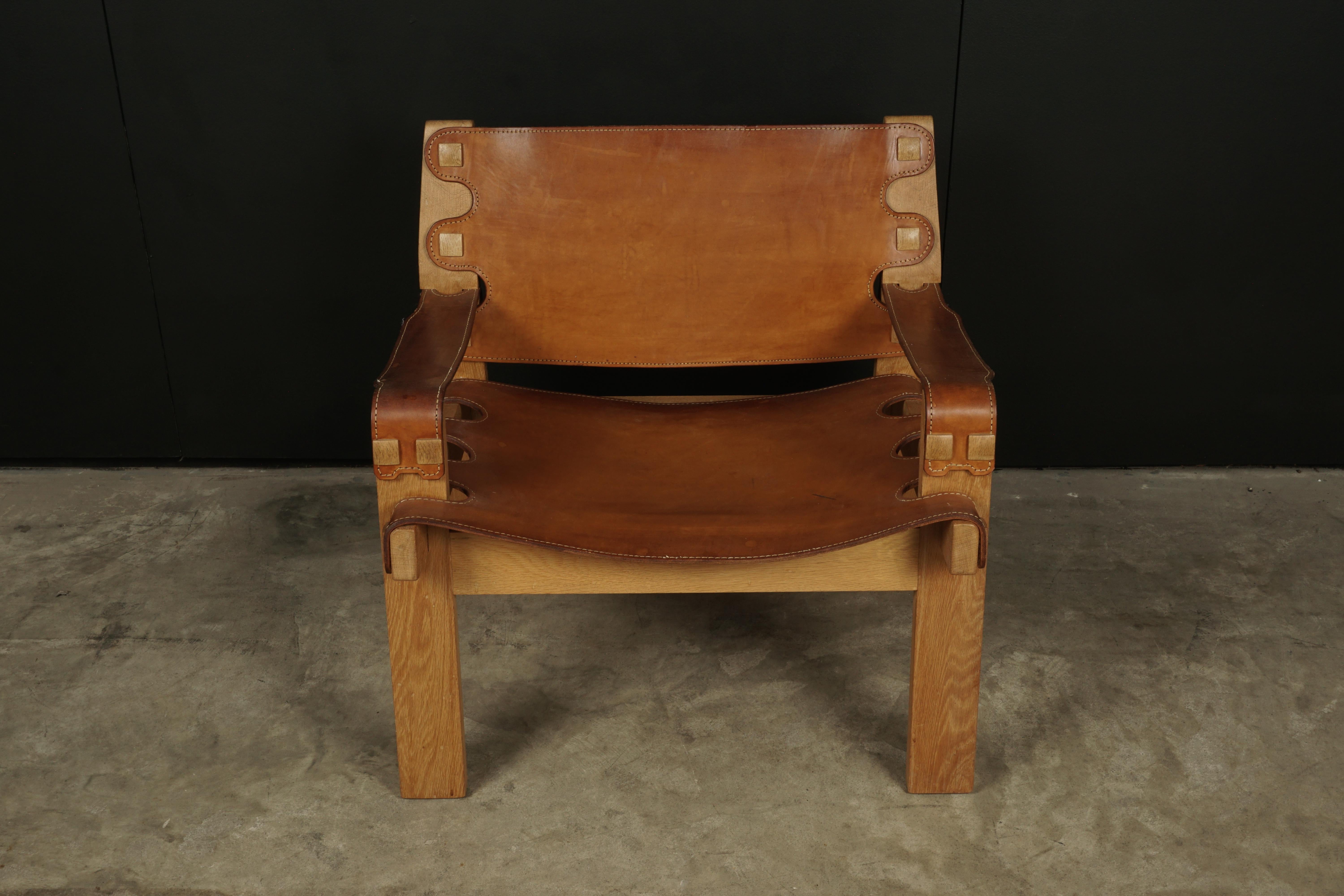 Rare leather lounge chair from Denmark, circa 1970. Solid oak construction with thick harness leather. Nice original color and wear.