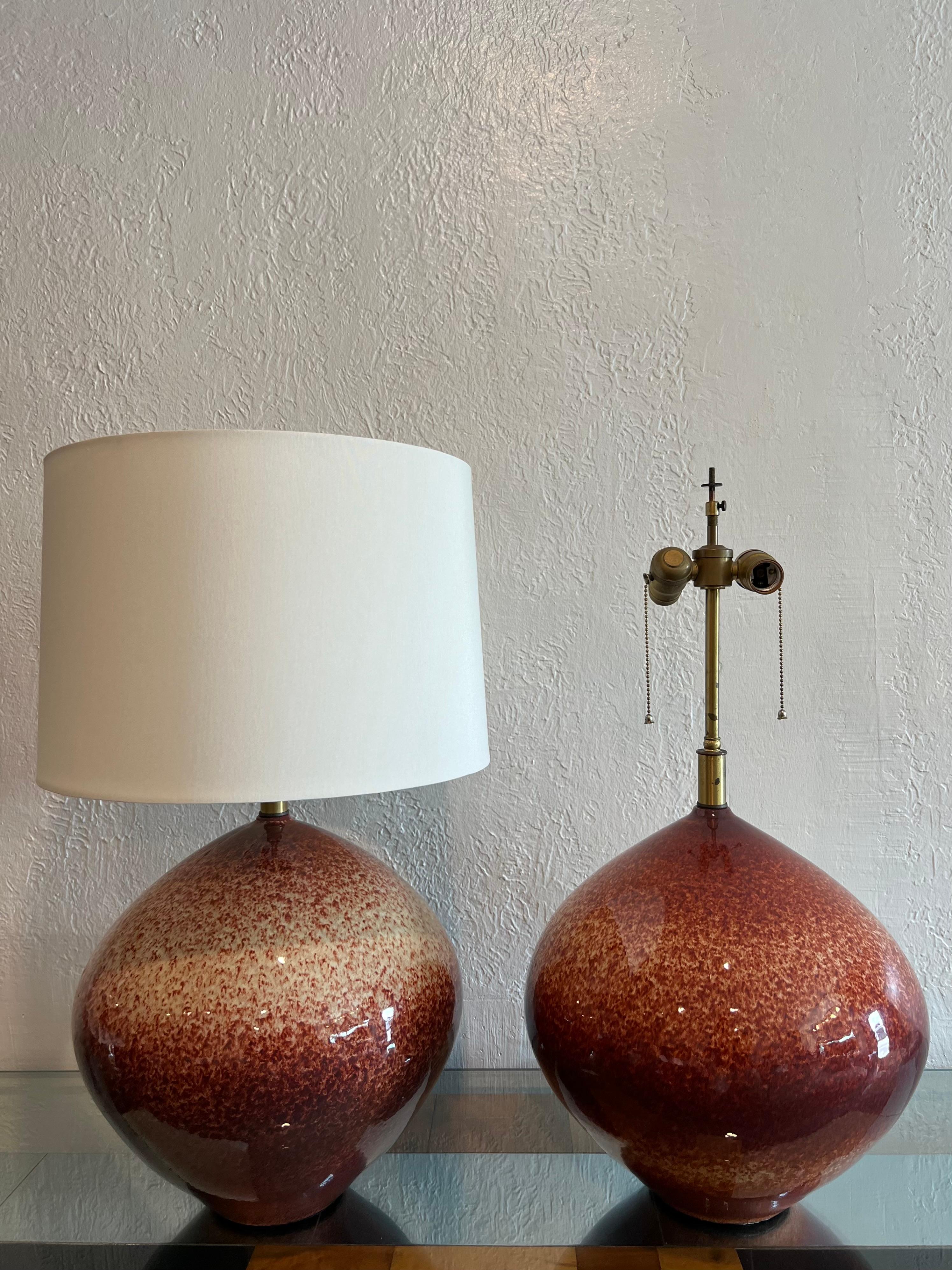 Rare pair of Leon Rosen for Design Technics table lamps. Each lamp has its own unique splatter pattern. Found in working order with original wiring and hardware. The lamps have been fitted with new drum shades. Measurements with shades are: 16D x