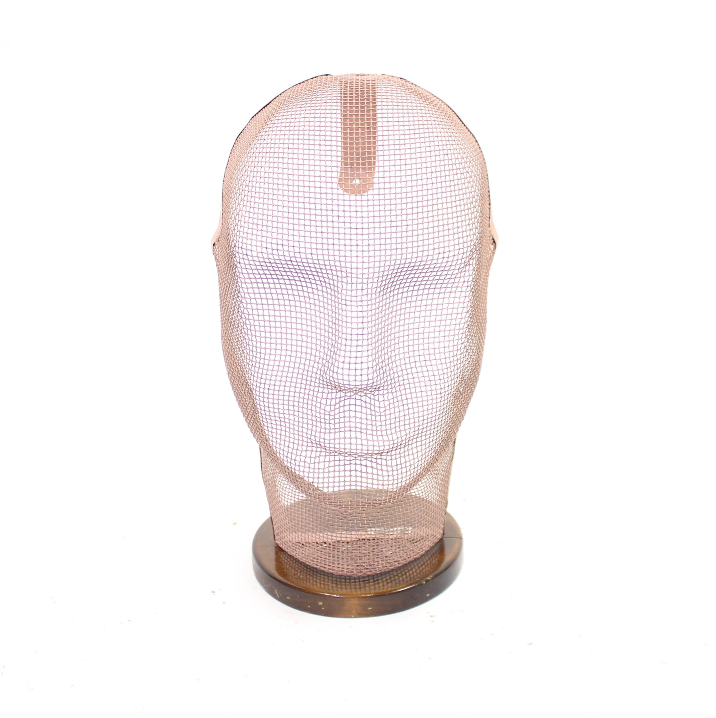 Very rare life size mannequin head, originally from an old haberdasher in Stockholm that recently closed. Made of pink painted steel mesh mounted on an old stained birch base. The head was originally intend to sit on the wall (and the wall mounting