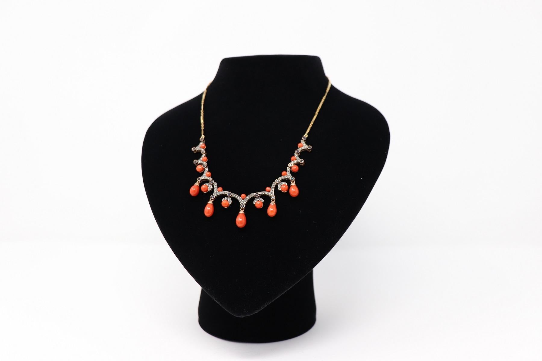Refined necklace in 18 karat gold chain characterized by drop-shaped coral pendants alternated with blue sapphires and diamonds. Necklace of great elegance Italian goldsmith production. This necklace ideal for an elegant summer evening.
