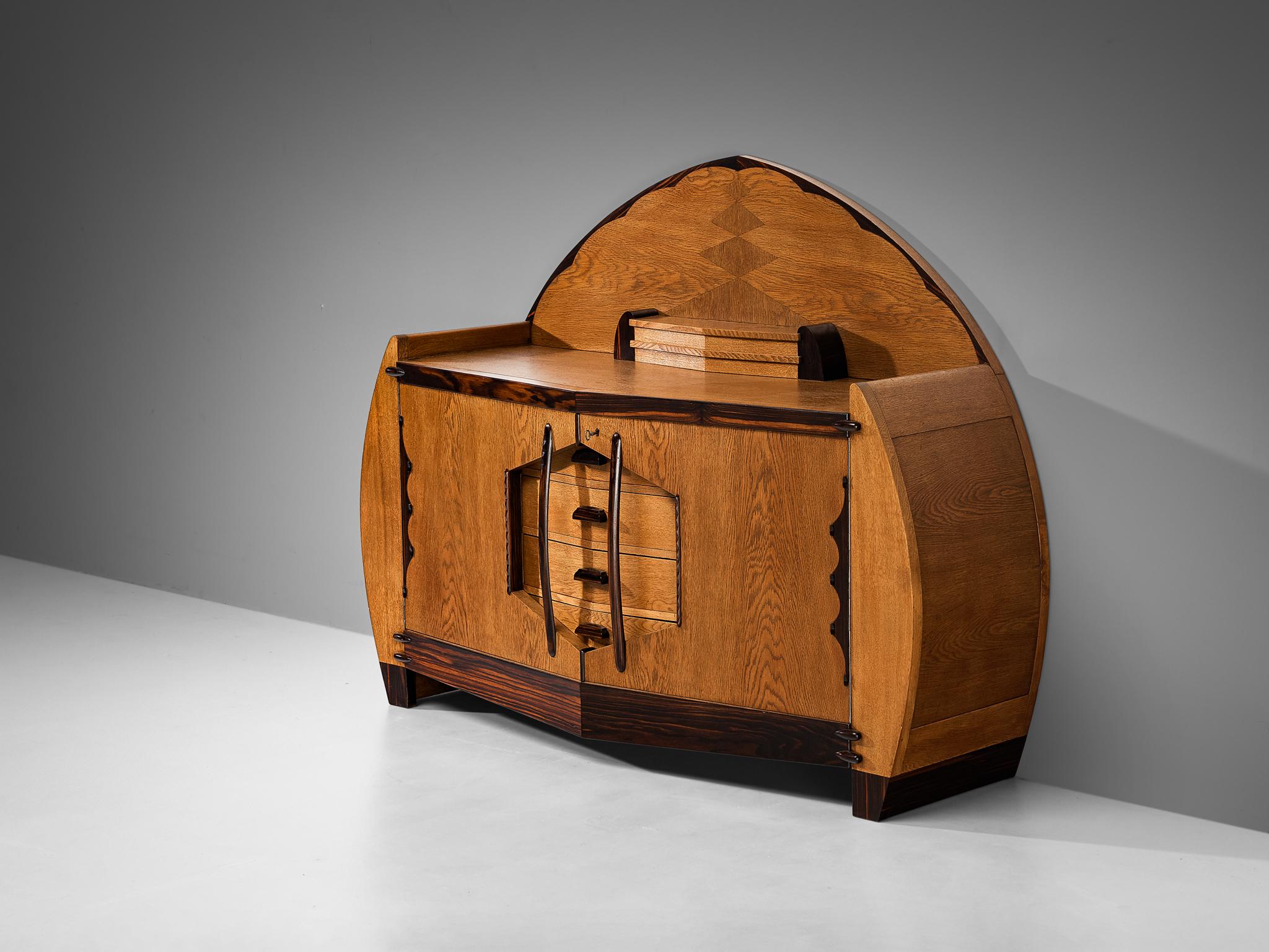 L.J. Verweij for Intima, sideboard, oak, coromandel, The Netherlands, 1920s

This extremely rare cabinet is designed by Dutch designer L.J. Verweij for Intima in the 1920s. Although little has been known about this creator, this design truly