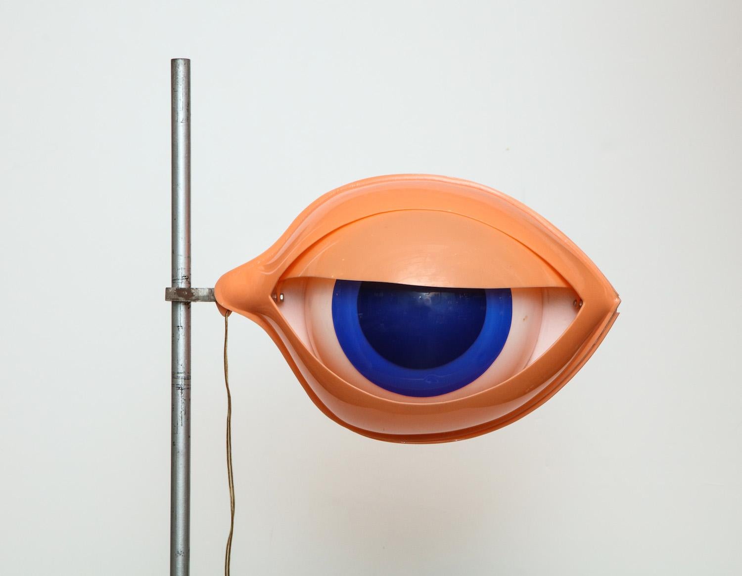 Iconic design by Nicola L. Heavy-gage plastic “eye” sculpture with interior illumination. Steel base and rod. Adjustable height.