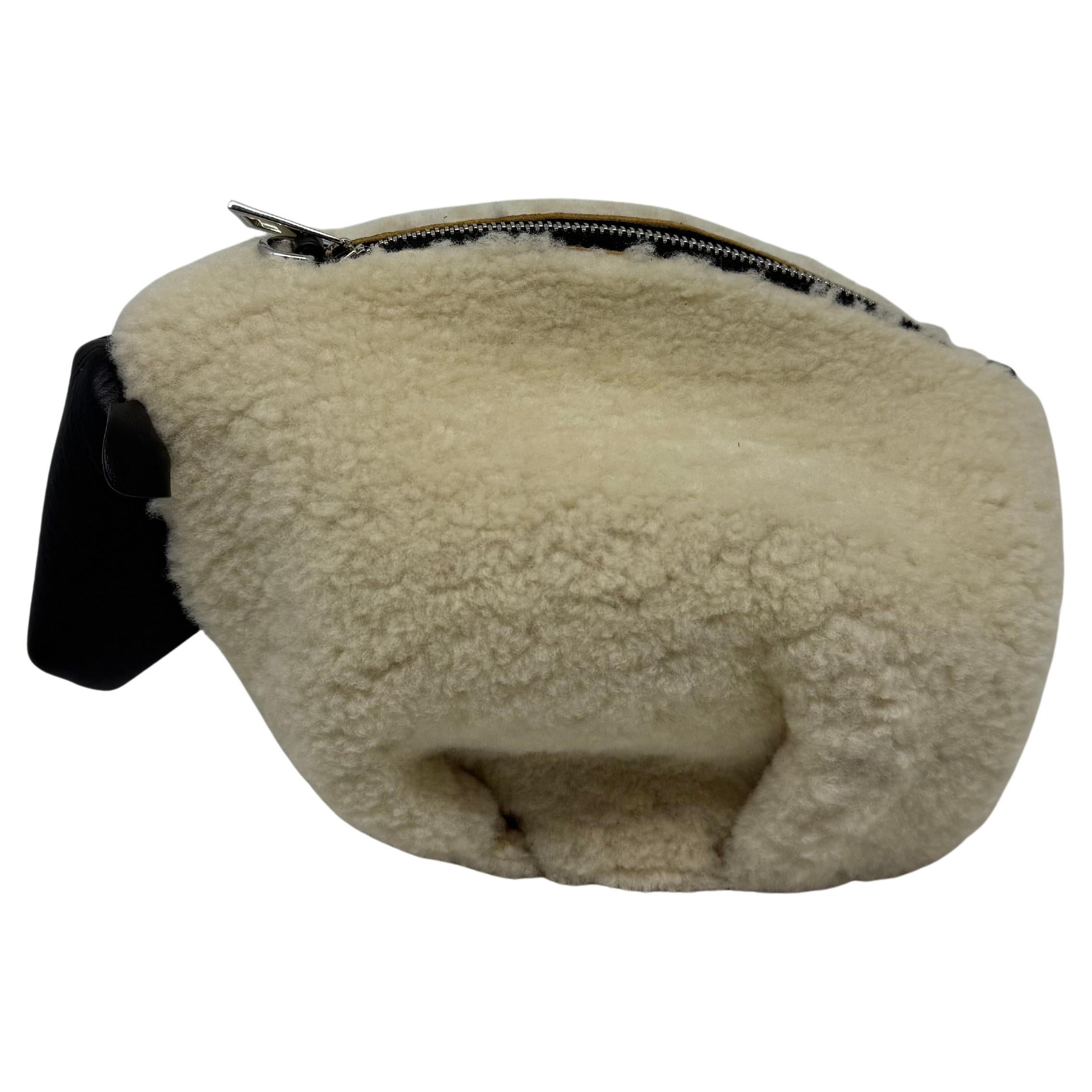 Very cute Loewe sheep mini bag. Comes with adjustable strap, can be worn as a clutch, shoulder or crossbody. Hard to come by. Overall in good condition with minor marks due to wear on the shearling. Comes with its strap, dust bag and box
