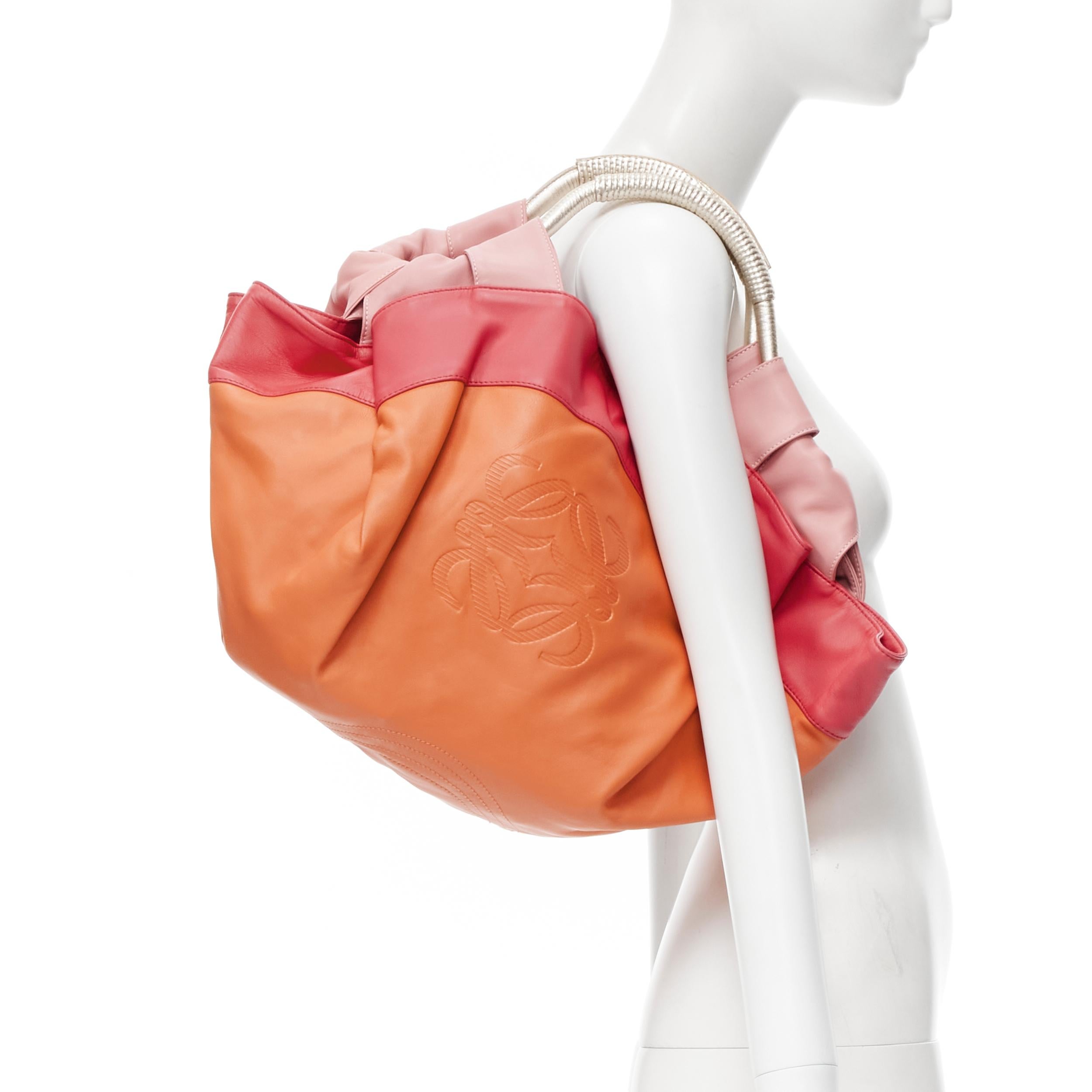 rare LOEWE Nappa Aire Brisa orange red gold handle dumpling bag 
Reference: CELG/A00025 
Brand: Loewe 
Model: Nappa Aire Brisa 
Material: Leather 
Color: Orange 
Pattern: Solid 
Closure: Magnet 
Made in: Spain 

CONDITION: 
Condition: Excellent,