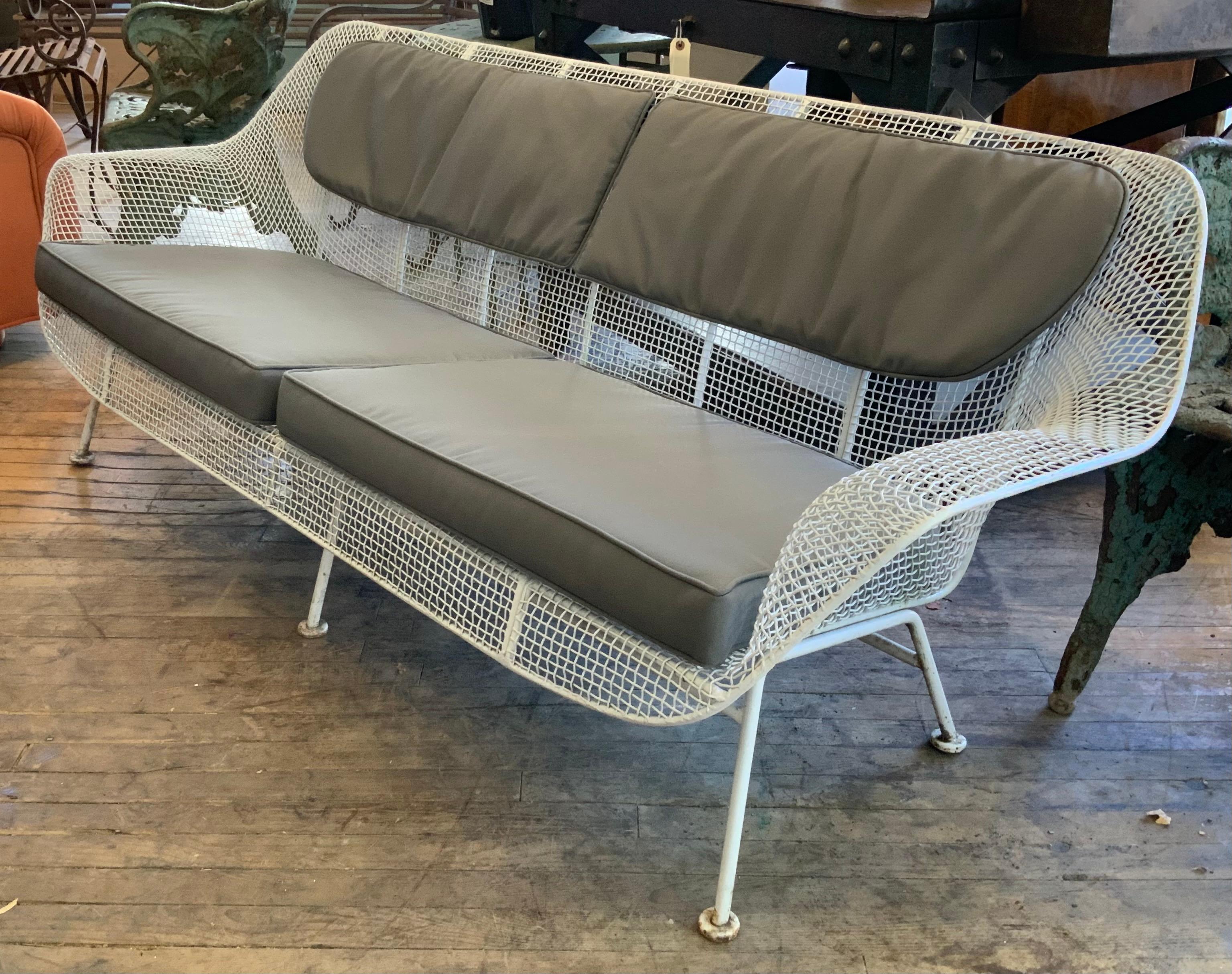 A rare example of Russell Woodard's iconic sculptura long sofa in wrought iron and woven steel mesh. Beautiful proportions in this wide and deep lounge sofa make this very comfortable and stylish. Newly refinished in satin greige or can be finished