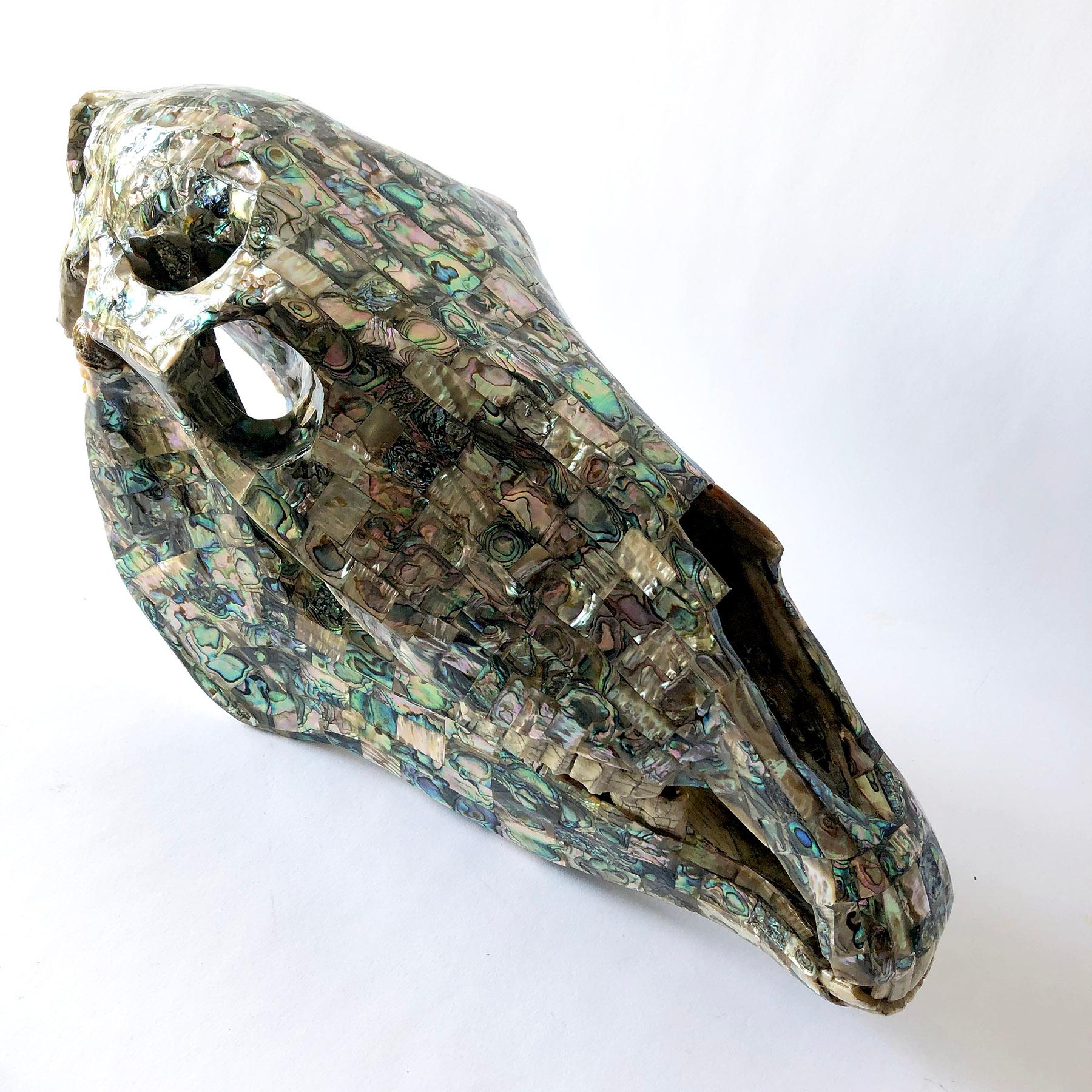 A rare abalone tiled horse skull sculpture with articulating jaw created by Los Castillo of Taxco, Mexico. Sculpture measures 11