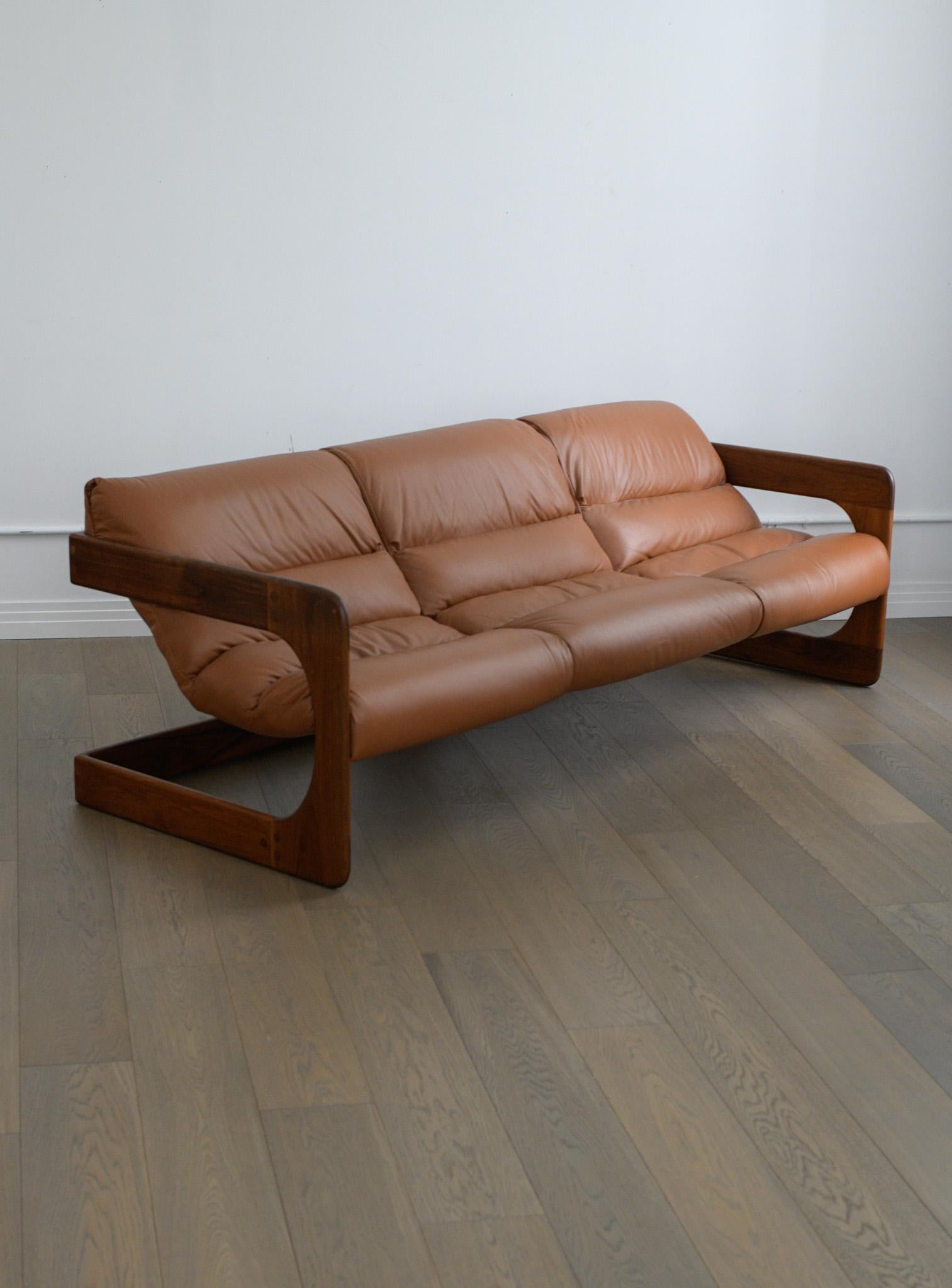 This incredibly rare and iconic 70's Sling sofa by Lou Hodges for California Design Group has been restored and is in beautiful condition. 

Both the cantilevered Oak frame and leather sling have been professionally refinished & reupholstered and