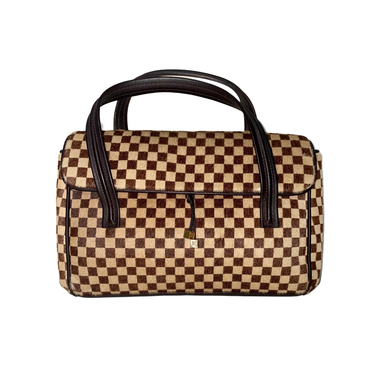 Stunning Louis Vuitton Top Handle Bag
In the famous Louis Vuitton Damier motif
Made of finest calf fur
Cube details in front engraved with 