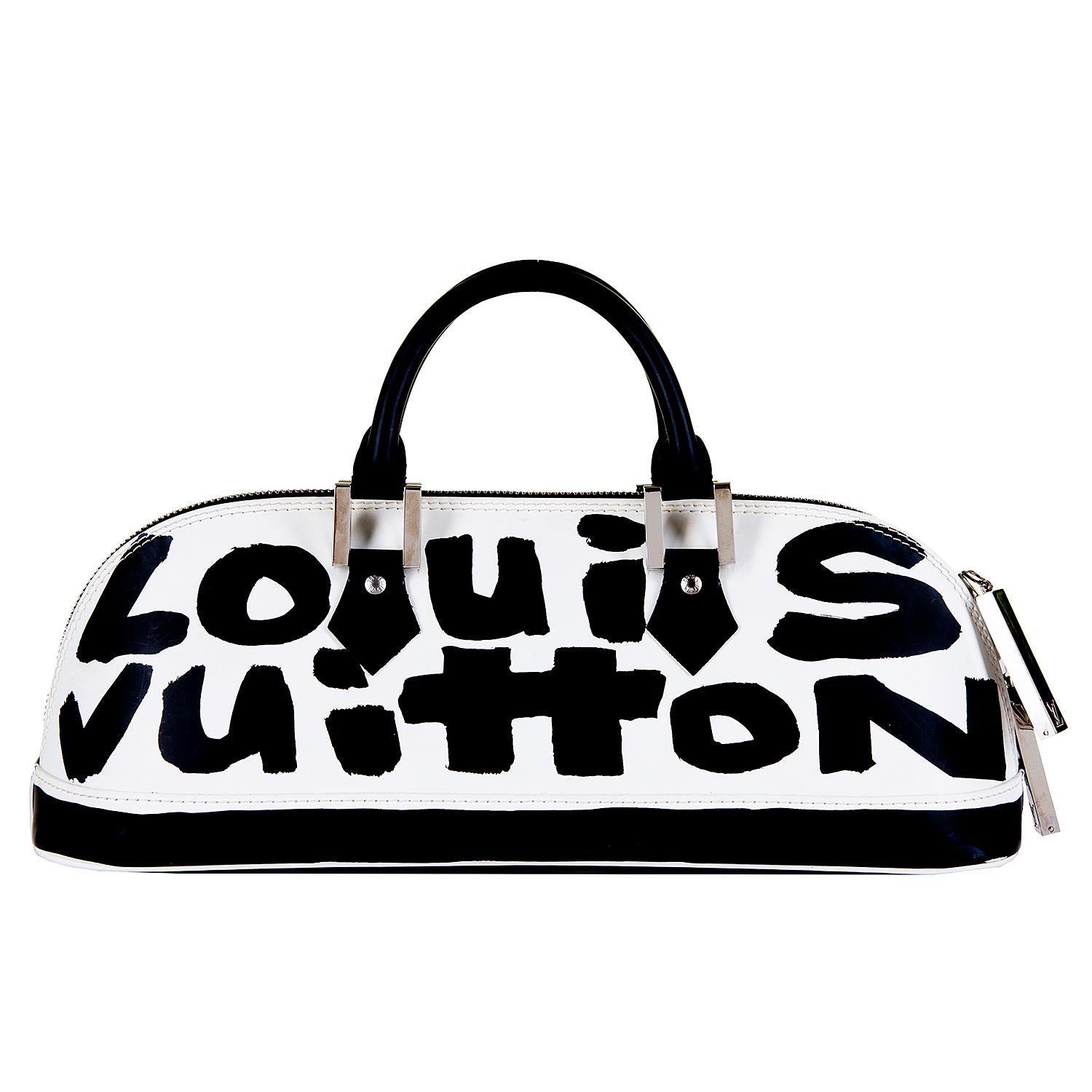 In pristine condition this rare Louis Vuitton Bag, is by the legendary designer Stephen Sprouse. From the East/West Collection, this Alma bag is finished in black & white Glace leather accented with silver tone hardware.