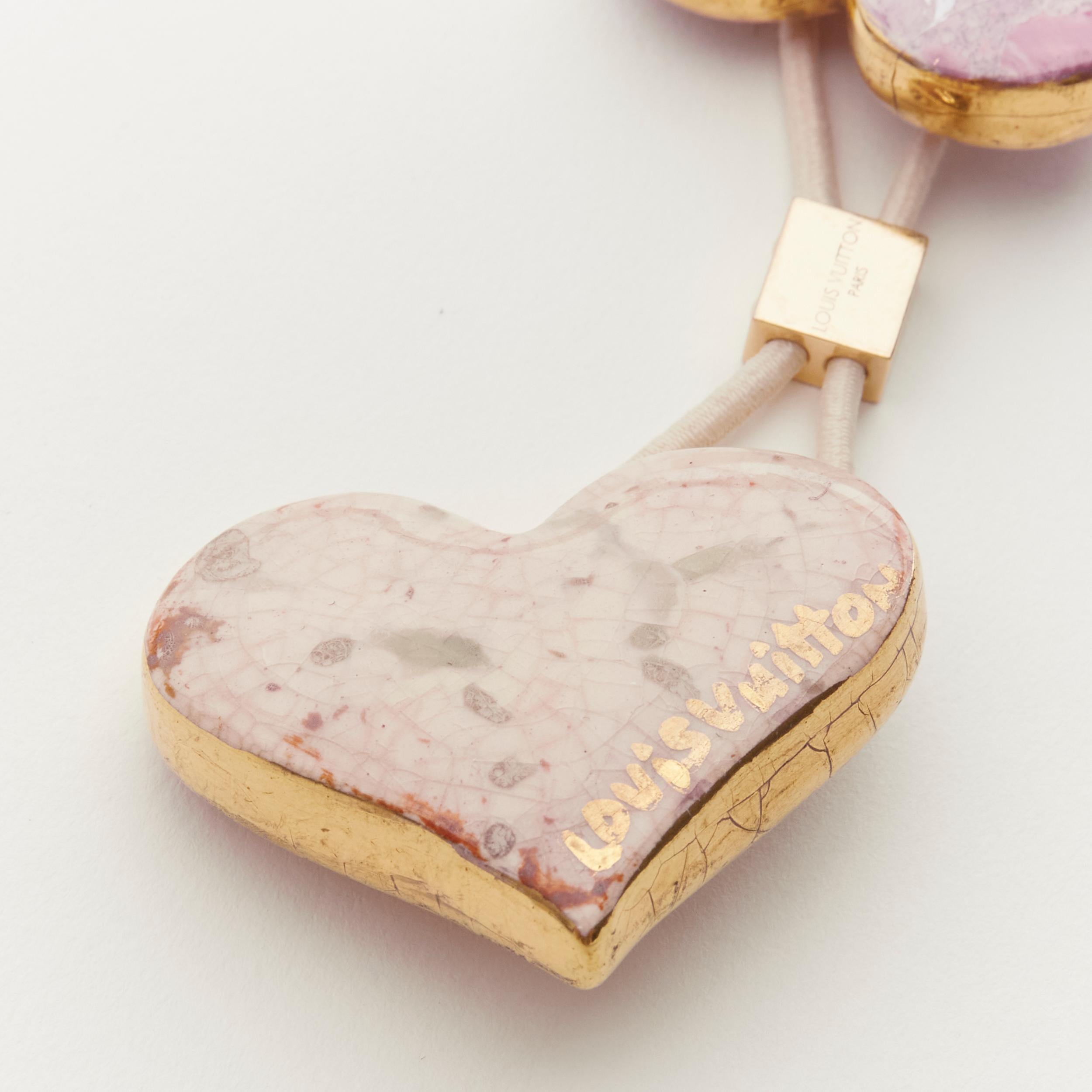 rare LOUIS VUITTON Stephen Sprouse pink stone enamel heart floral hair tie 
Reference: ANWU/A00135 
Brand: Louis Vuitton 
Designer: Marc Jacobs 
Collection: Stephen Sprouse 
Material: Metal 
Color: Pink 
Pattern: Solid 
Extra Detail: LOUIS VUITTON