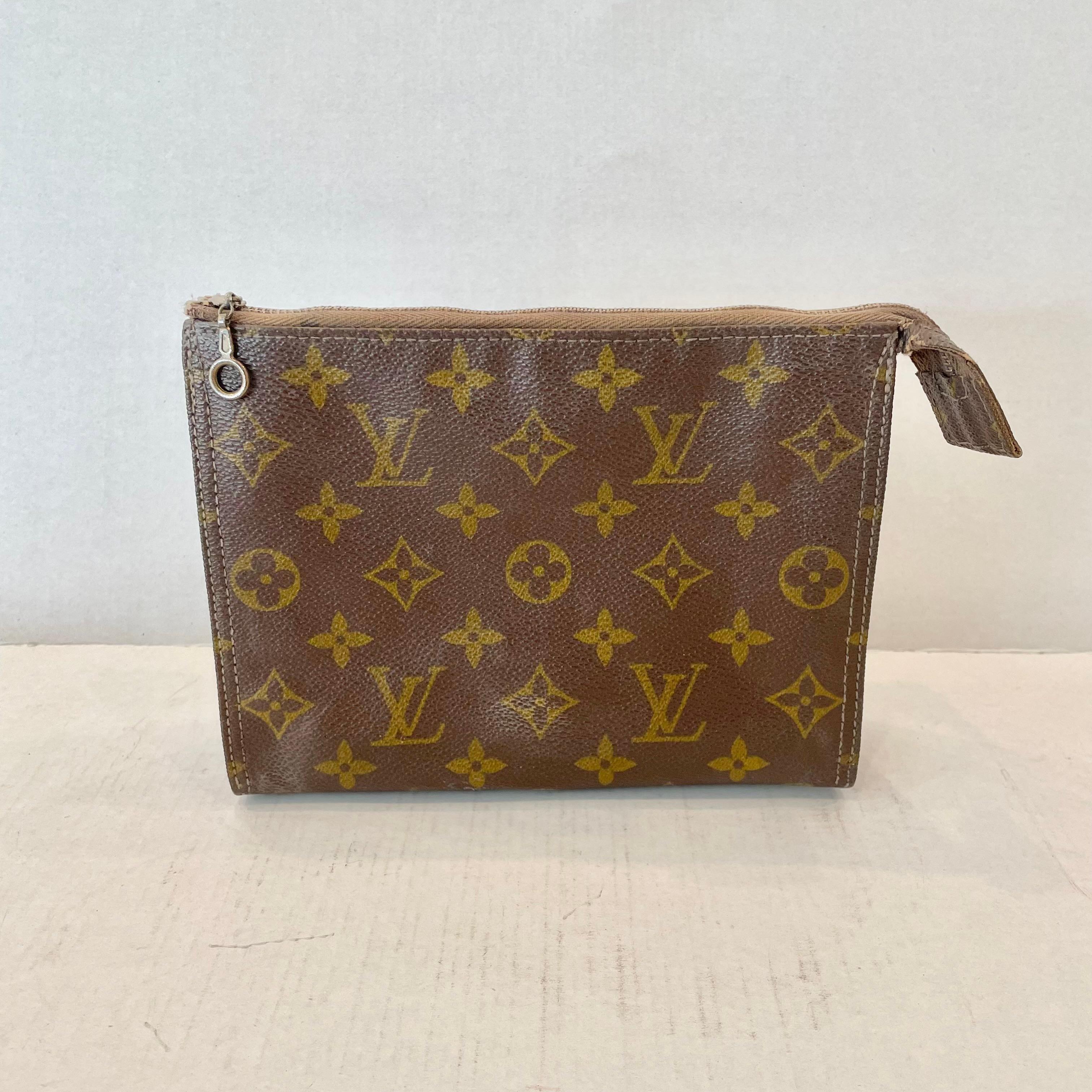 Louis Vuitton cosmetic bag, 1960s. Perfect for toiletries while traveling or for money and important documents. Also, great little accessory for storing makeup in your purse. Comes with a leather interior lining and Louis Vuitton tag. The case is