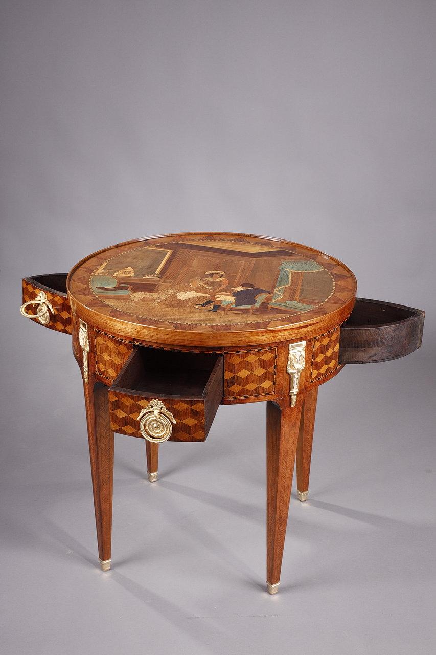 Louis XVI style game table with its stopper made of veneer inlaid with different species. In the upper part, it is flanked by two drawers and two flaps in wood veneer with geometric marquetry called 