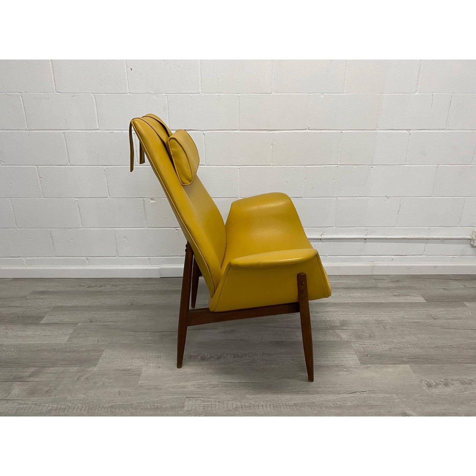 Rare mid century lounge chair by Arthur Umanoff for Madison Furniture. Circa 1960's with original mustard yellow vinyl upholstery has some wear. Makers tag intact. Walnut finish on frame shows vintage wear and could be refinished. No structural