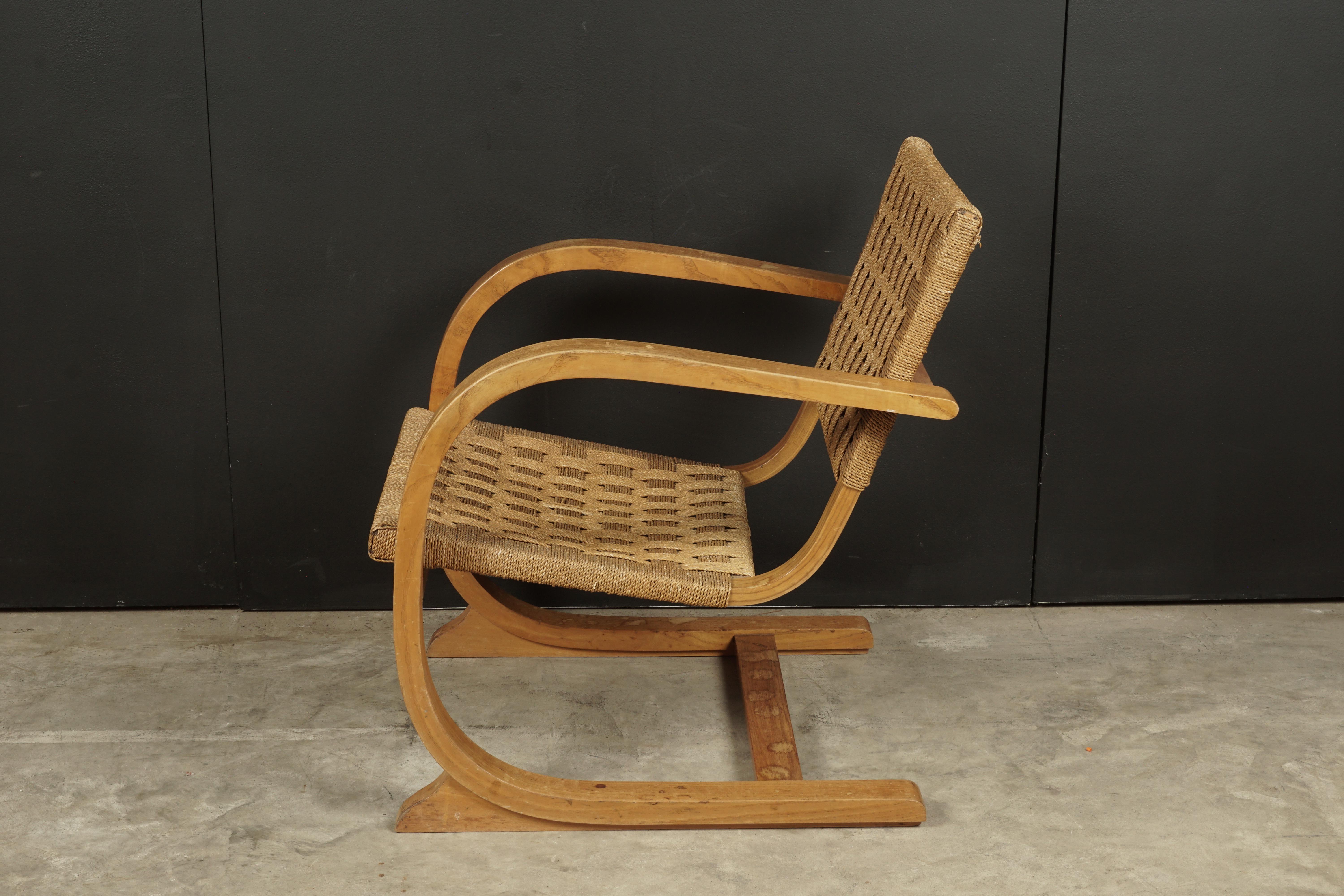 Vintage midcentury woven lounge chair designed by Bas Van Pelt, Netherlands. Bent oakwood frame with braided rope on the seat and back.
