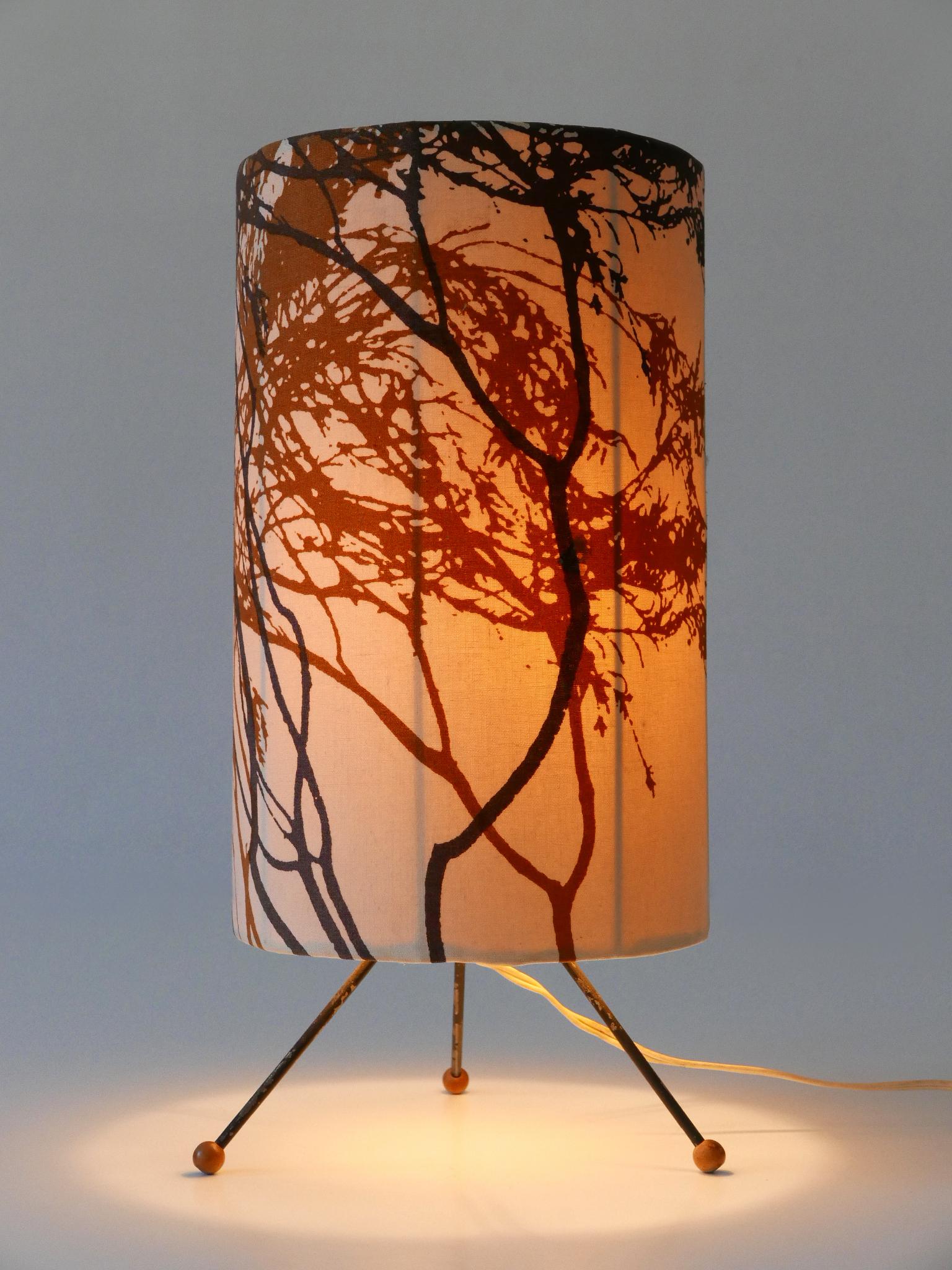 Rare and lovely Mid-Century Modern bedside table lamp. Designed & manufactured probably in Austria, 1950s.

Executed in metal and fabric, the table lamp comes with 1 x E27 / E26 Edison screw fit bulb socket, is wired, in working condition and runs