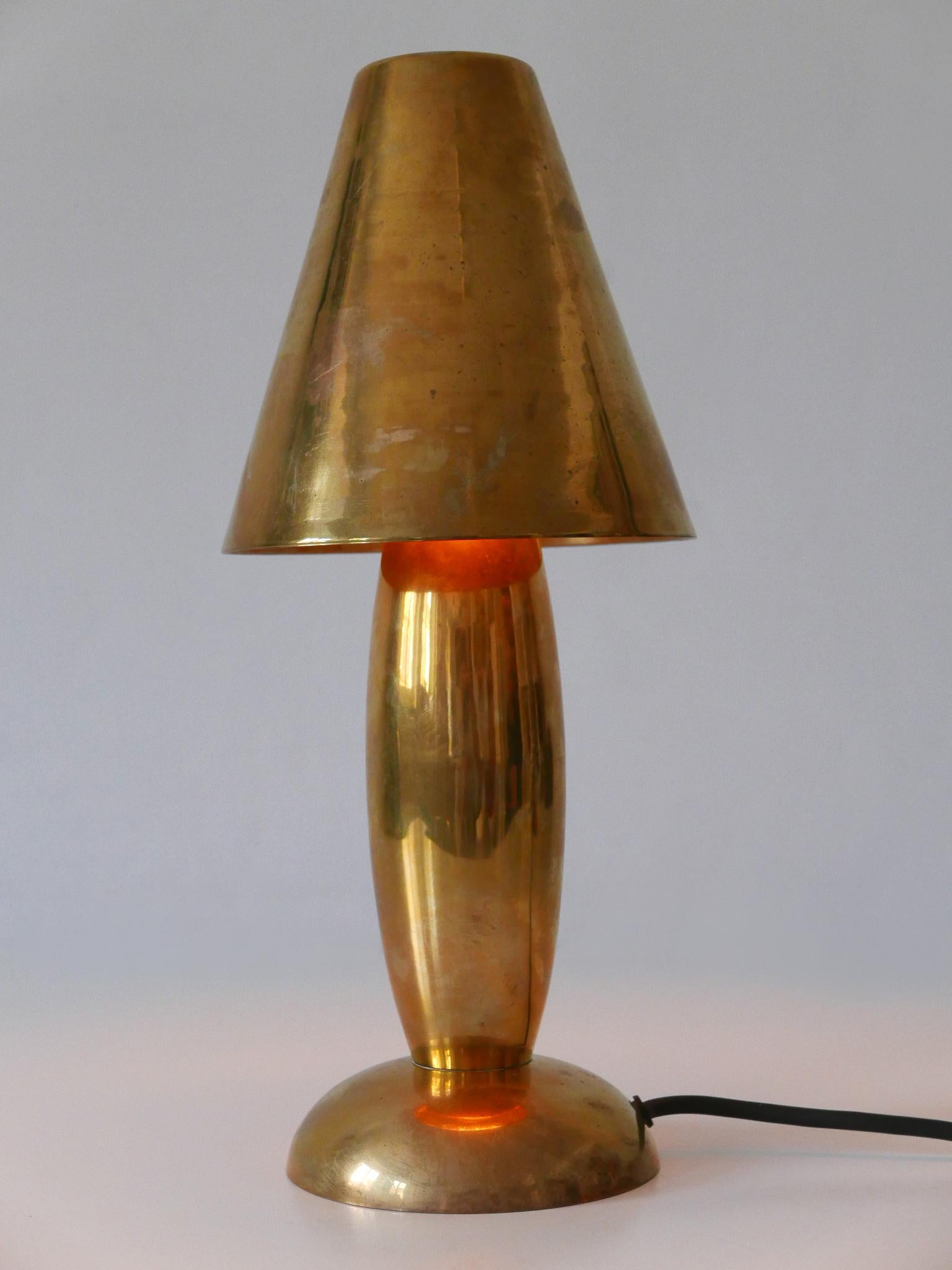 Rare and elegant Mid-Century Modern side table lamp with removable shade. Designed and manufactured by Günther Lambert, Germany, 1970s.

Executed in heavy and solid brass, the lamp comes with 1 x E14 / E12 Edison screw fit bulb socket, is wired, in