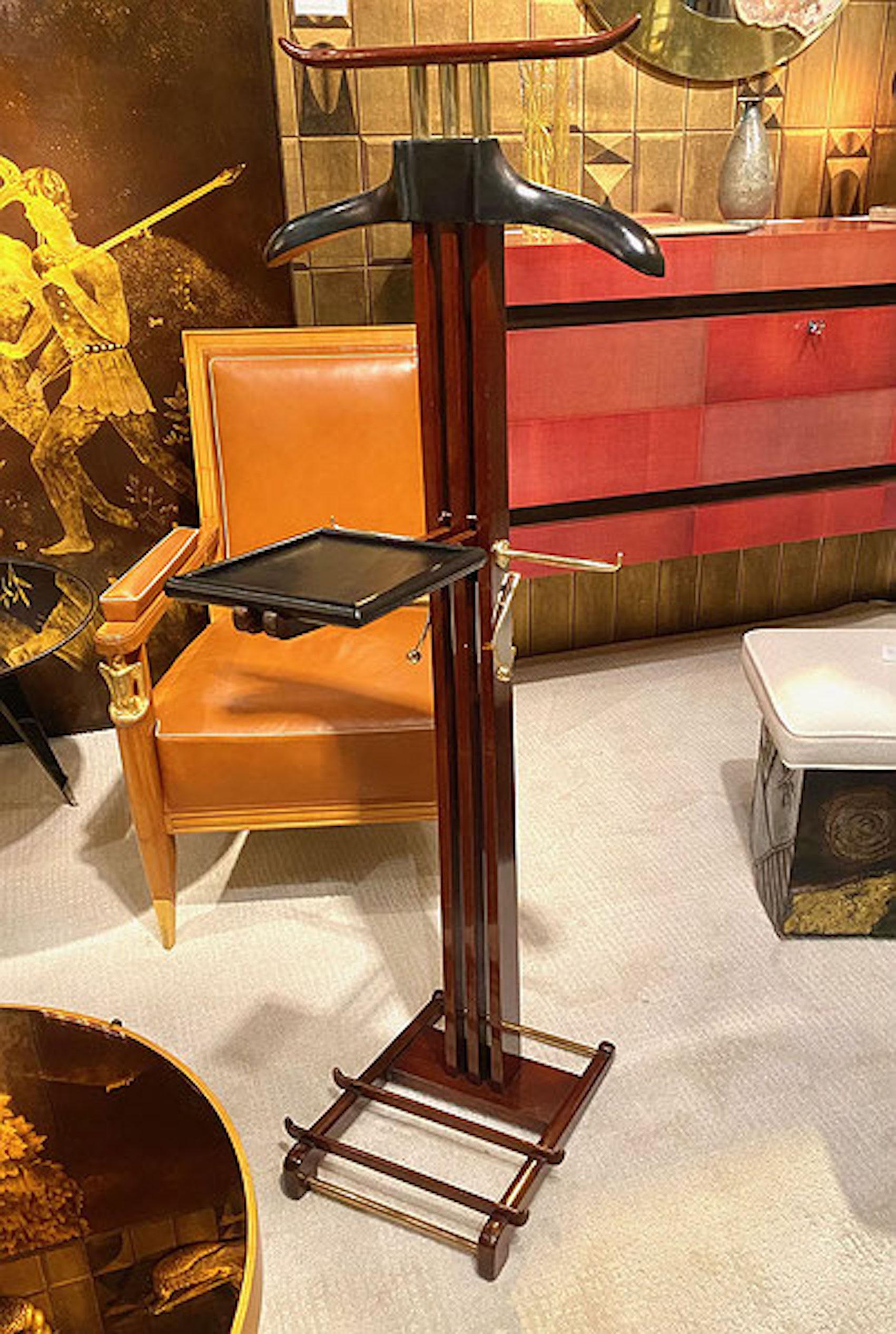 Rare Mahogany gentleman's valet by Paul Dupré Lafon for Hermès. The coat hanger and foldable shelf covered in black stitched leather, also fitted with two polished brass tie hooks and the base fitted with a polished brass shoe rack. Paul Dupré Lafon