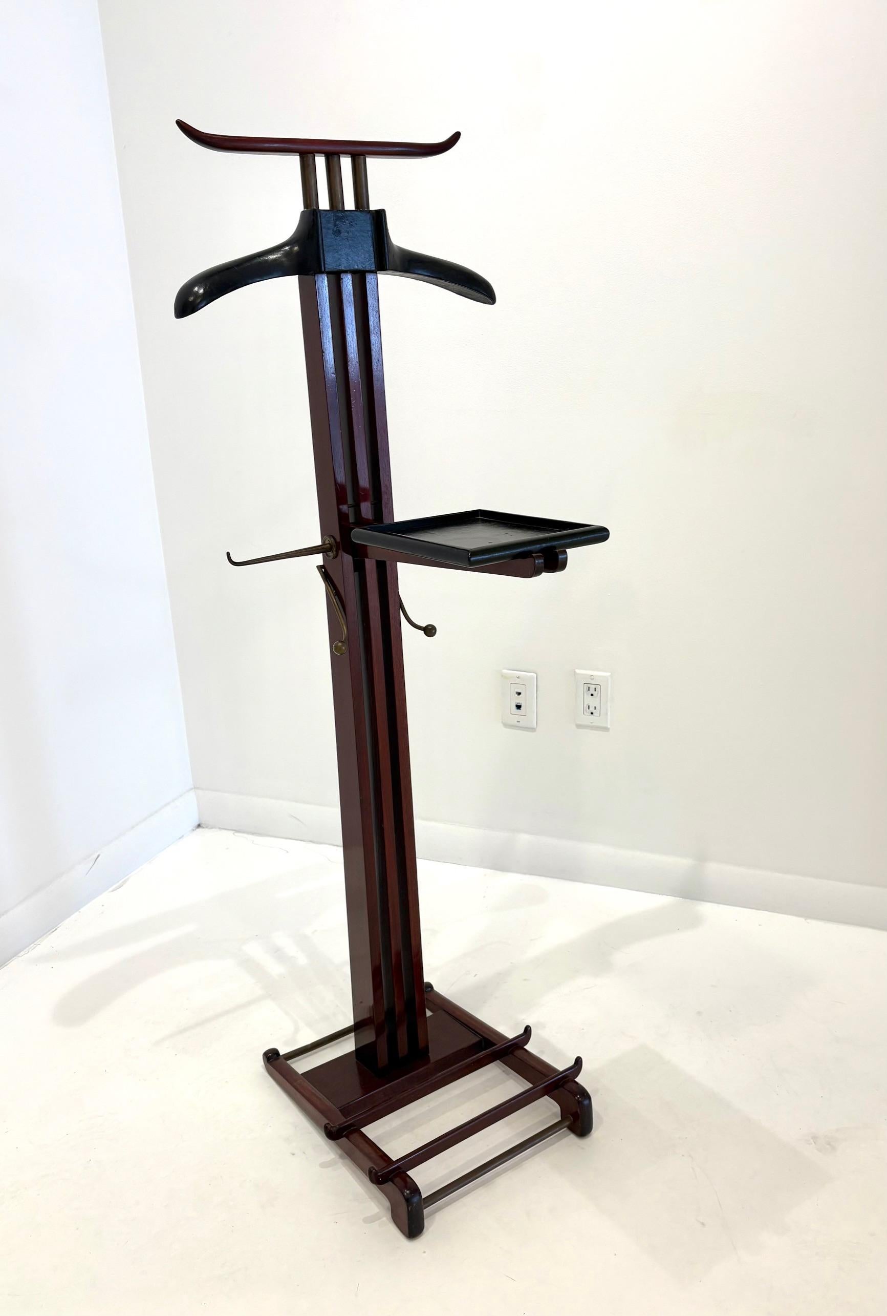 Rare Mahogany gentleman's valet by Paul Dupré Lafon for Hermès. The coat hanger and foldable shelf covered in black stitched leather, also fitted with two polished brass tie hooks and the base fitted with a polished brass shoe rack. Paul Dupré Lafon