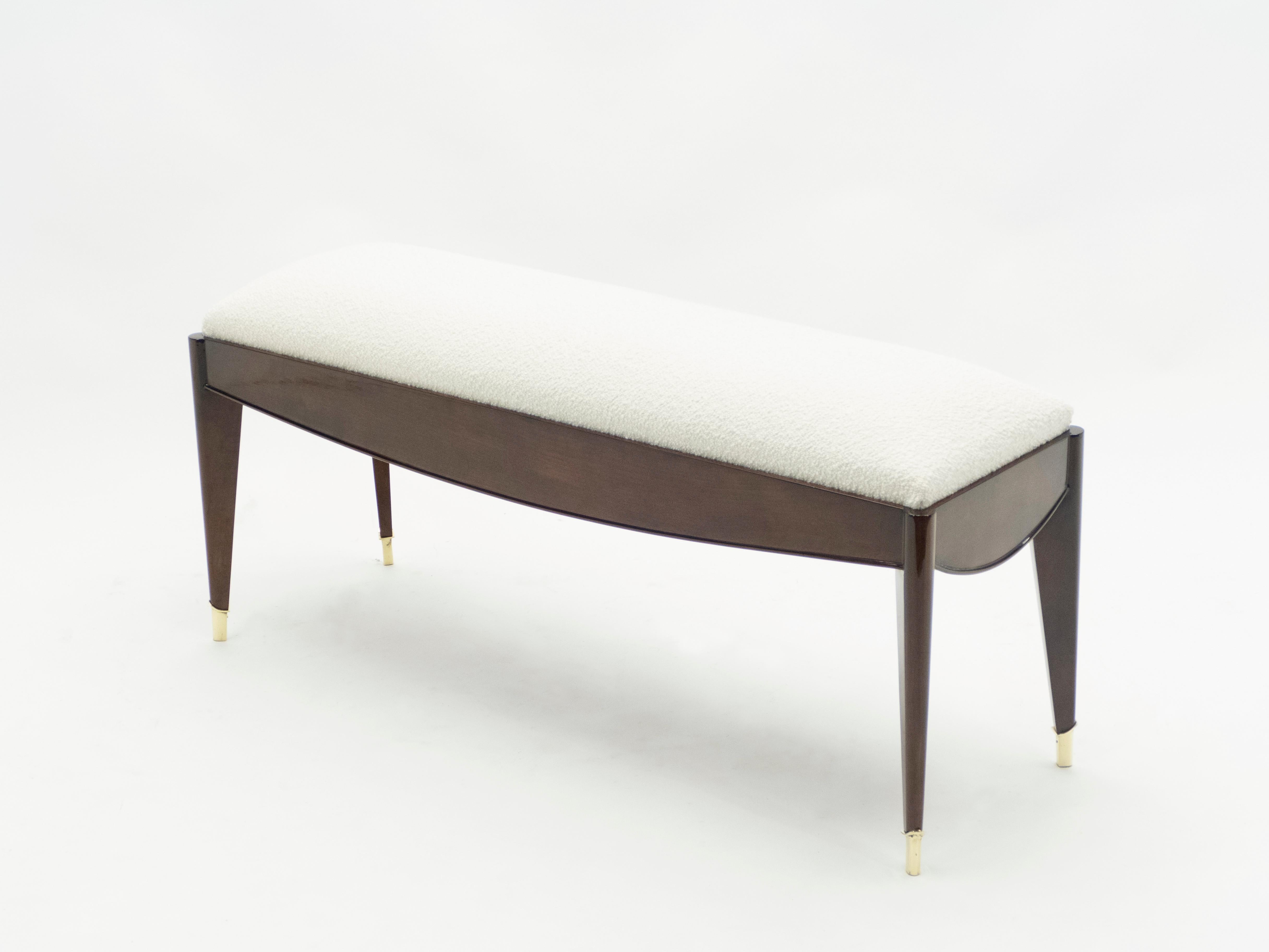 This beautiful French Art Deco bench was made in solid tinted walnut in the early 1940s by la Maison Dominique. The woodwork, pure line and brass sabots is just wonderful. Fully restored and newly upholstered with a wool bouclé from Lelièvre. This