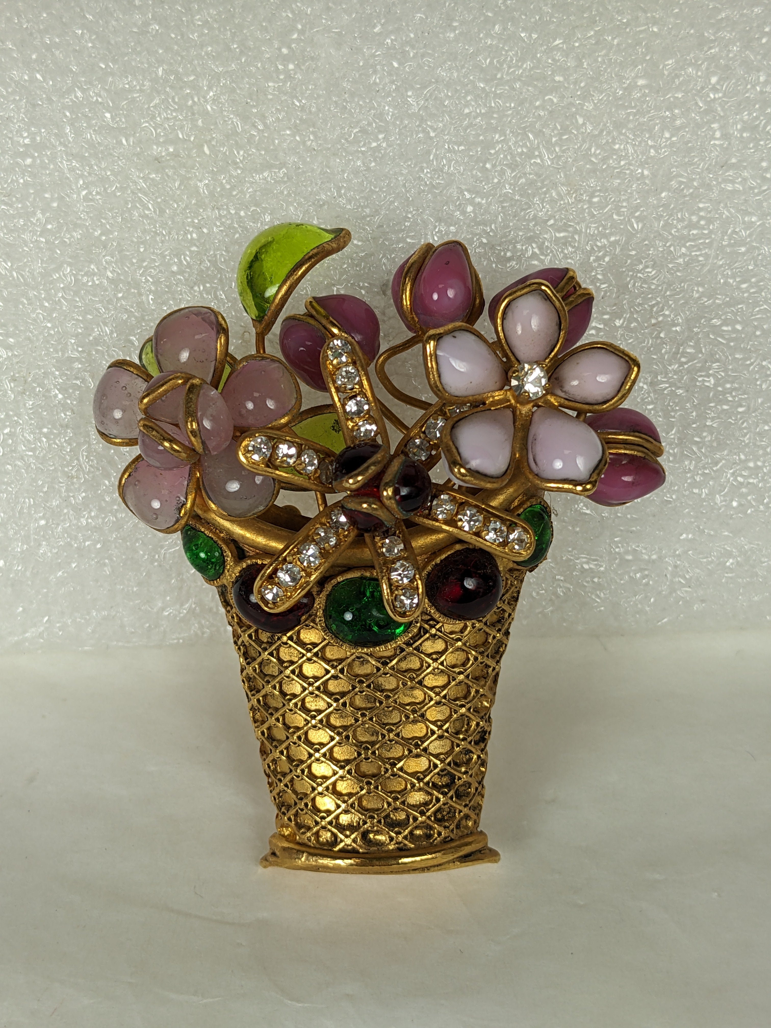 Rare and unusual Maison Gripoix Flower Basket Brooch from the 1950's. Crafted in a manner no longer possible with various blooms of hand made poured glass set in a filigree basket with jeweled ruby and emerald paste cabochon borders. Extraordinary