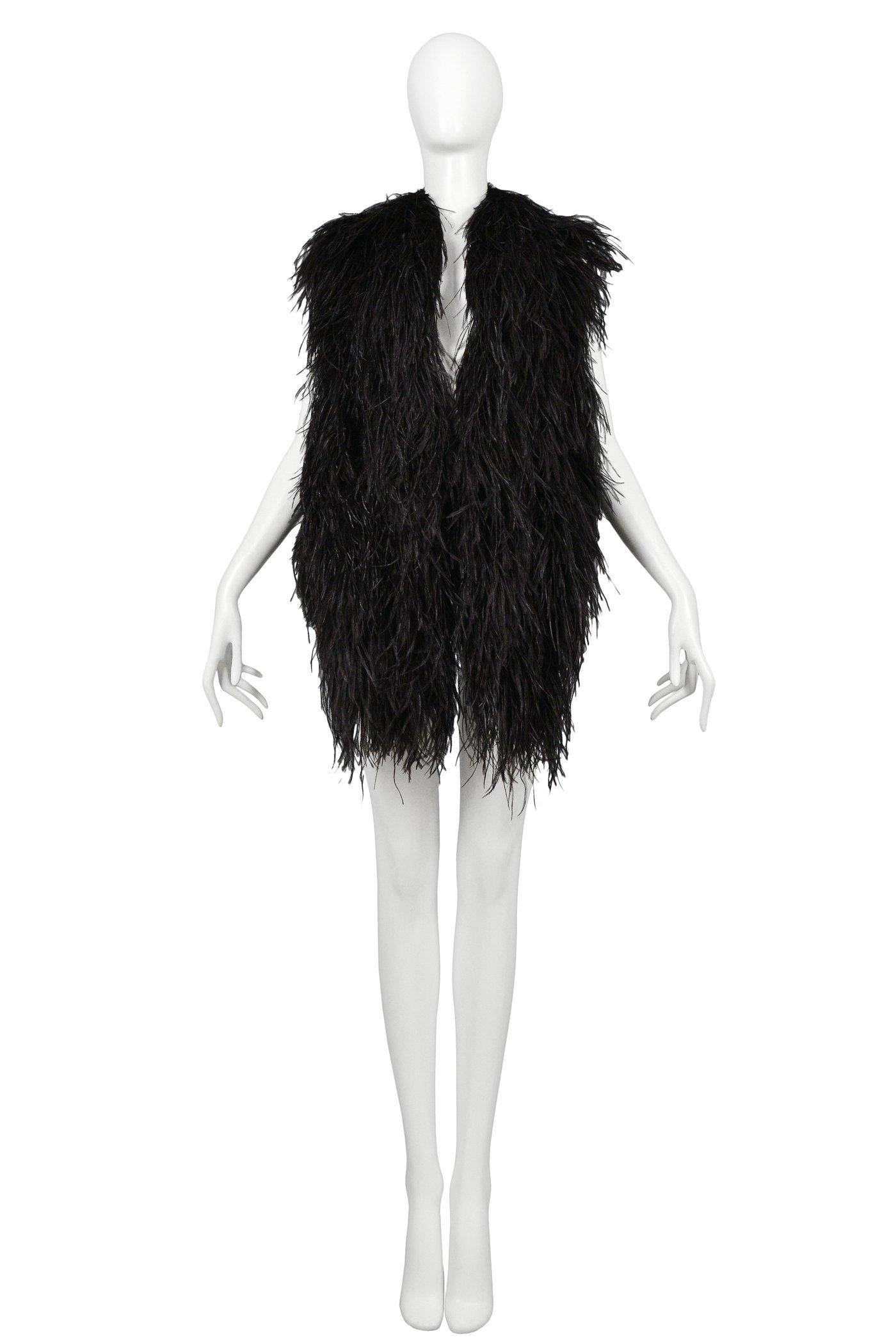 Resurrection Vintage is excited to offer a vintage Maison Martin Margiela black feather vest with a longer front, short back, large metallic label, and˙ bands at the back. Circa Autumn / Winter 1997-98

Maison Martin Margiela
Size: One