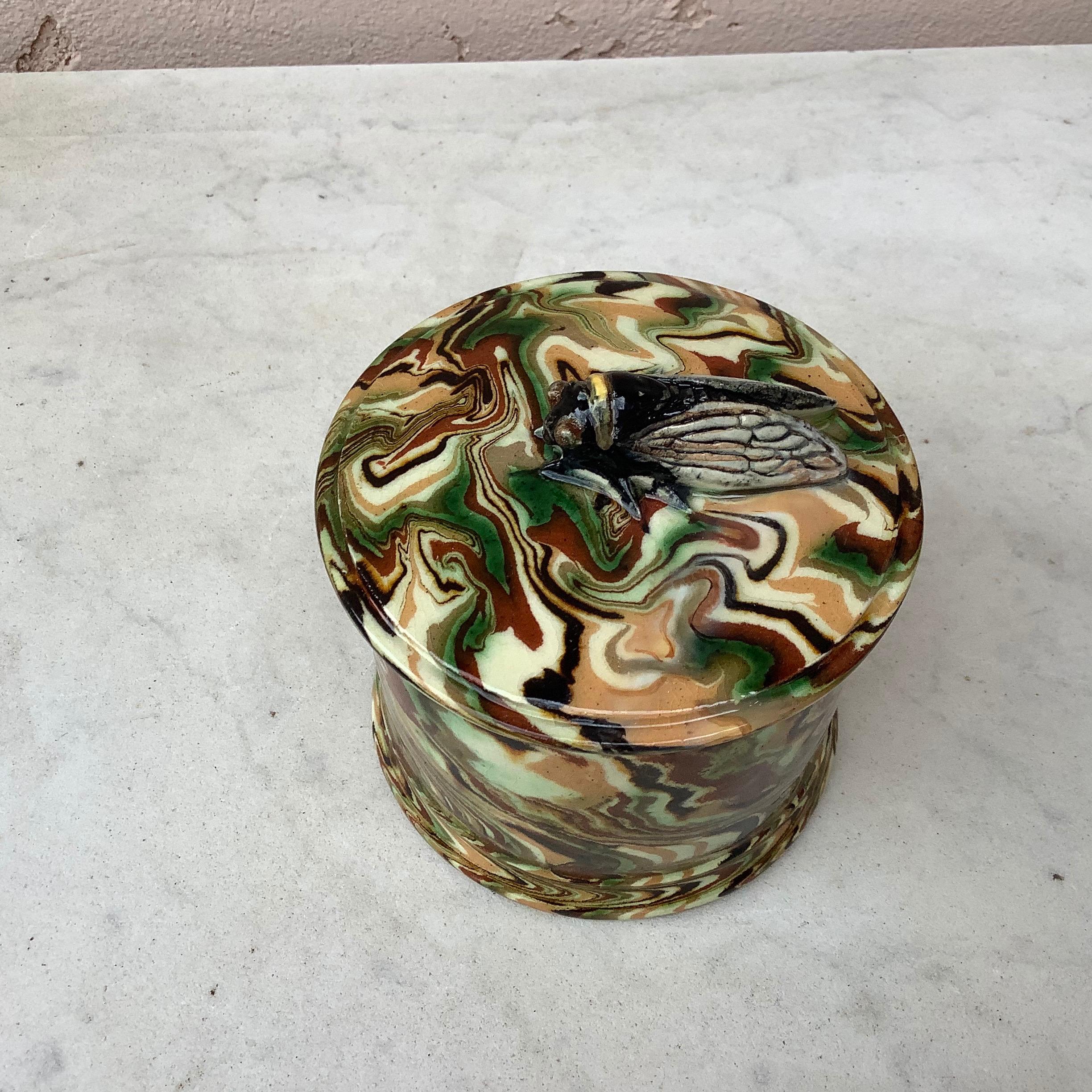 Rare Majolica box signed Pichon Uzes with cicada, circa 1890.
Pichon á Uzes is a family-owned pottery factory located in the town of Uzes in the south of France. The pottery has been in operation since 1802. In the 19th century, Pichon was a
